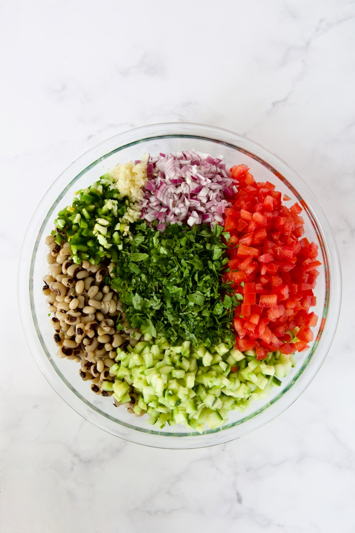 Ingredients for Black-Eyed Pea Salad in glass bowl before being combined.