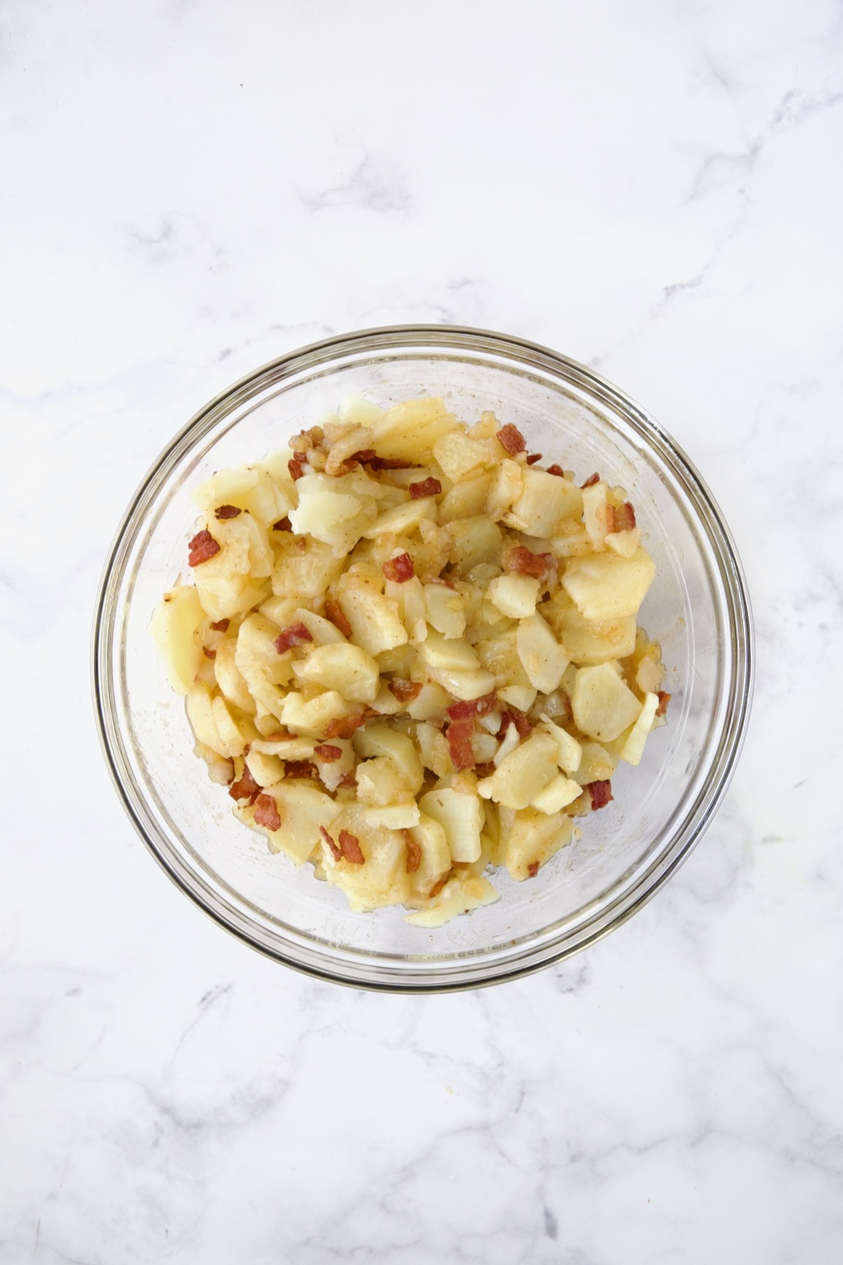 German Potato Salad in glass mixing bowl.