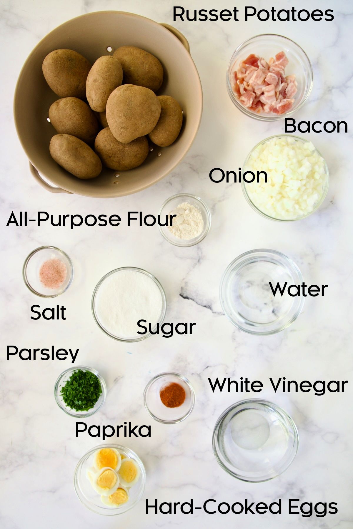 Ingredients for German Potato Salad in glass bowls.