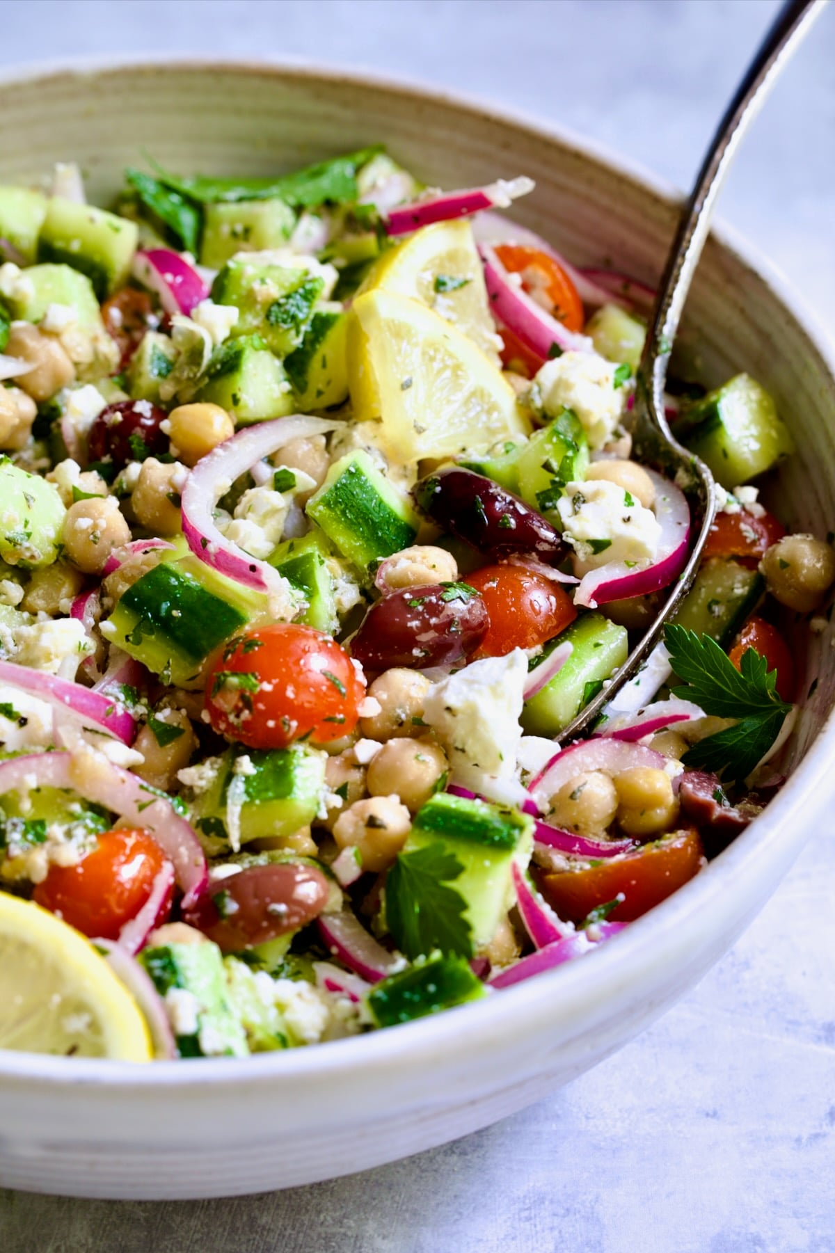 Greek Cucumber Salad with serving spoon.