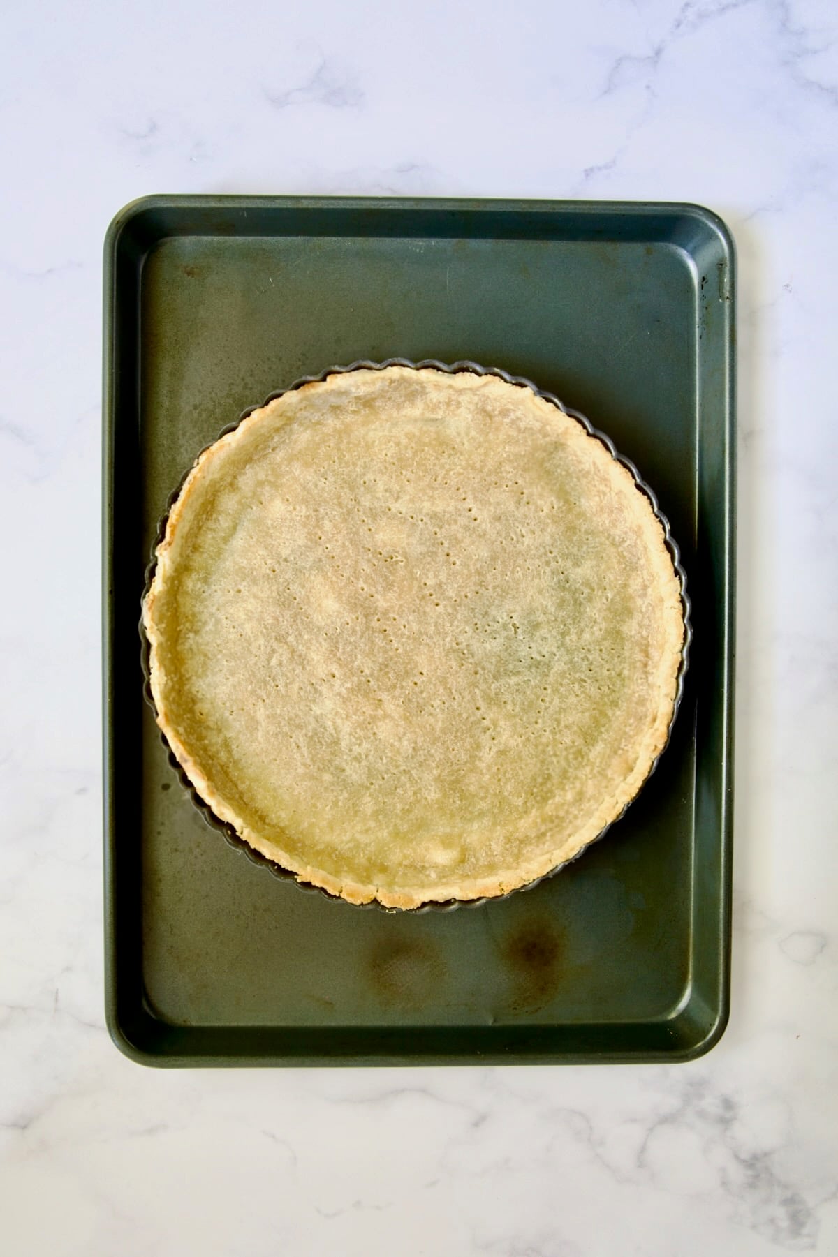 Baked tart crust on rimmed sheet pan.