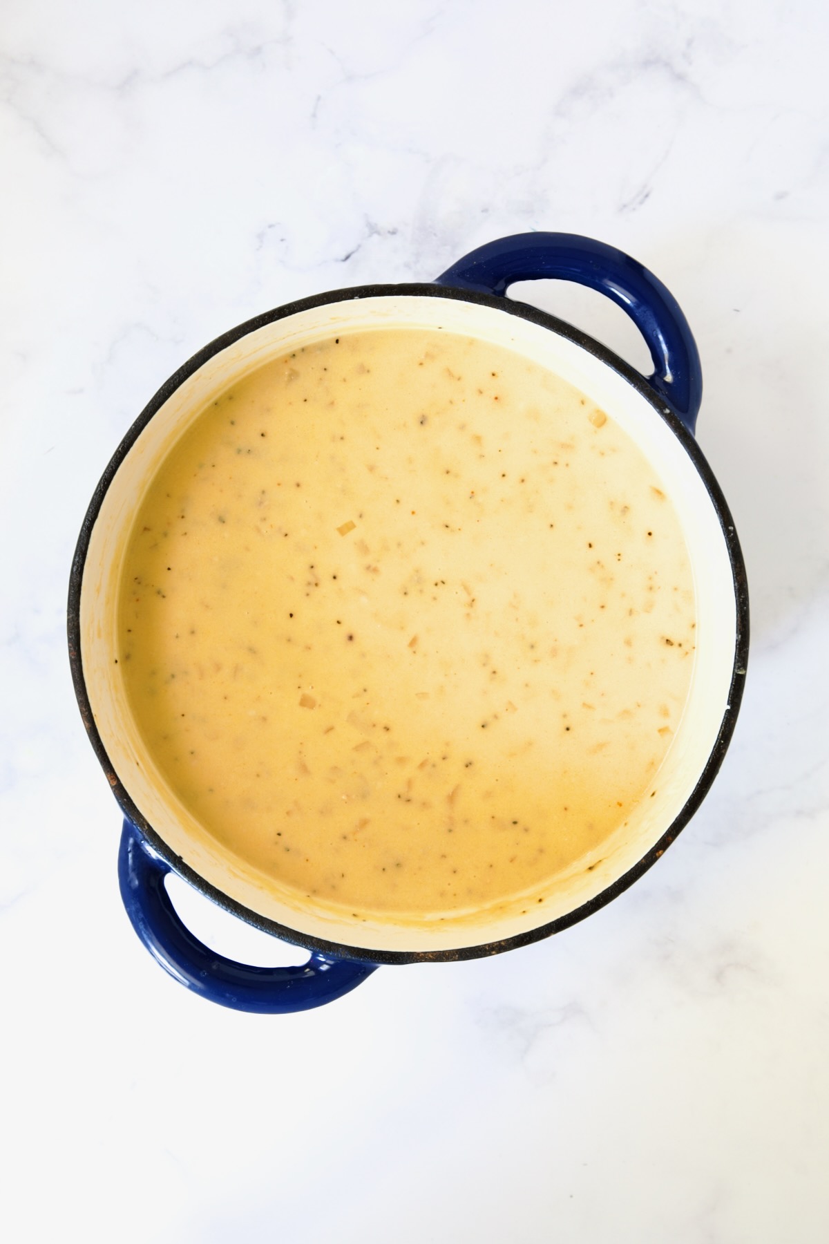 Cheddar Bacon Potato Soup in blue Dutch oven.