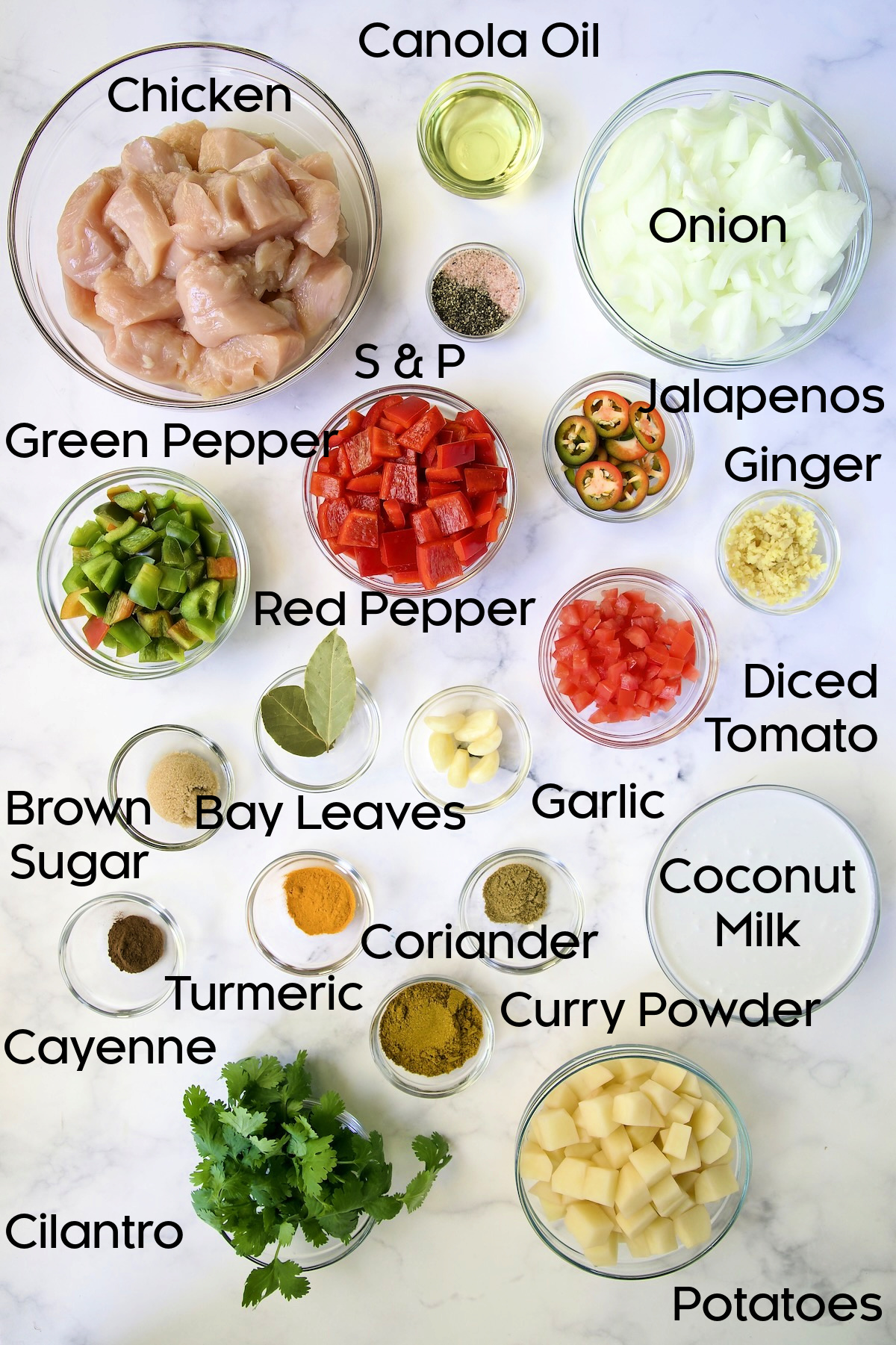 Ingredients for Chicken and Potato Curry in glass bowls.