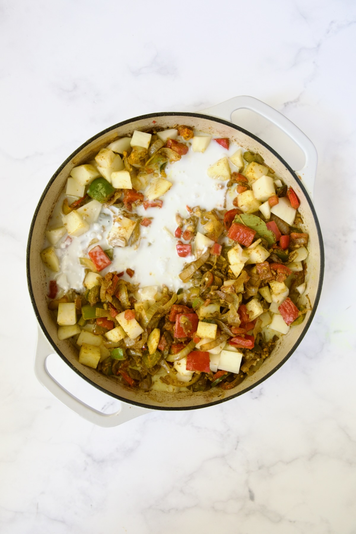 Coconut milk added to cooked vegetables and potatoes.