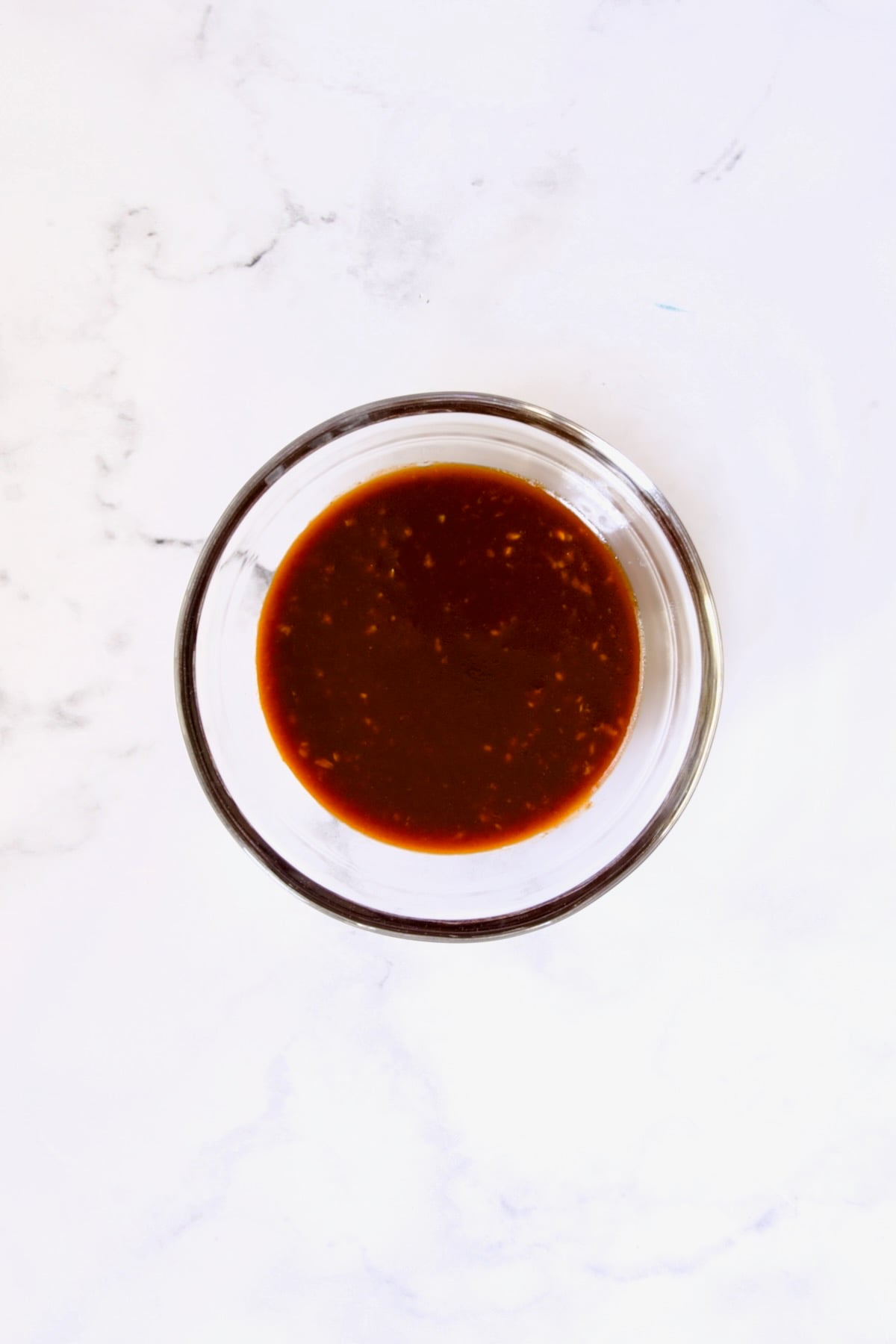 Sauce for eggplant in glass bowl.