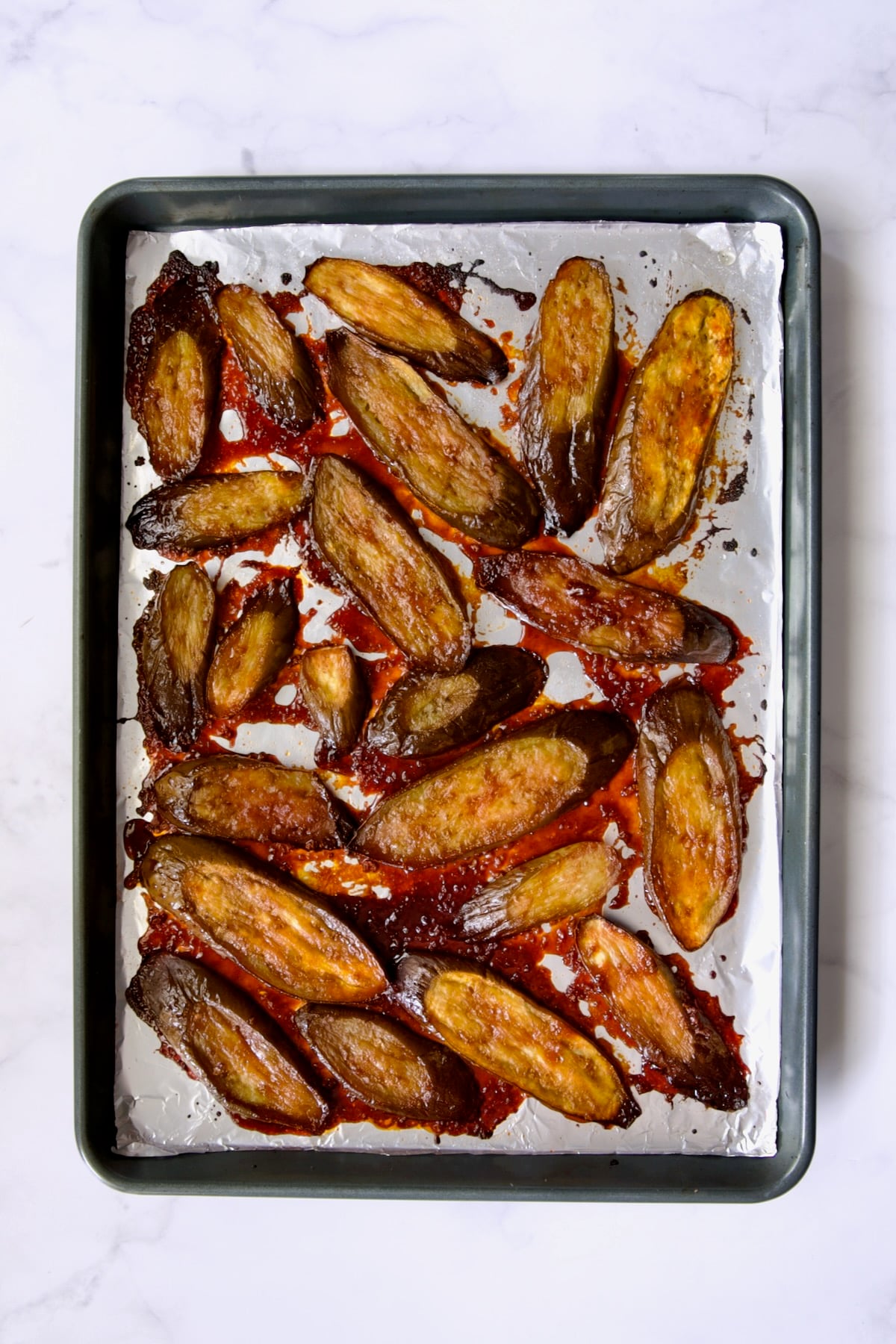 Broiled Gochujang Eggplant on aluminum foil-lined rimmed sheet pan.