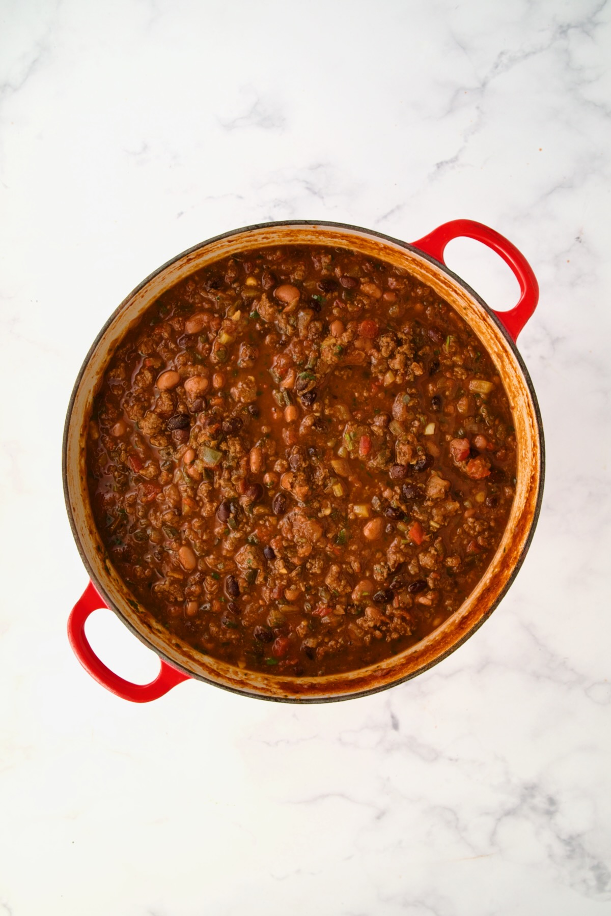 Finished chili in red Dutch oven.