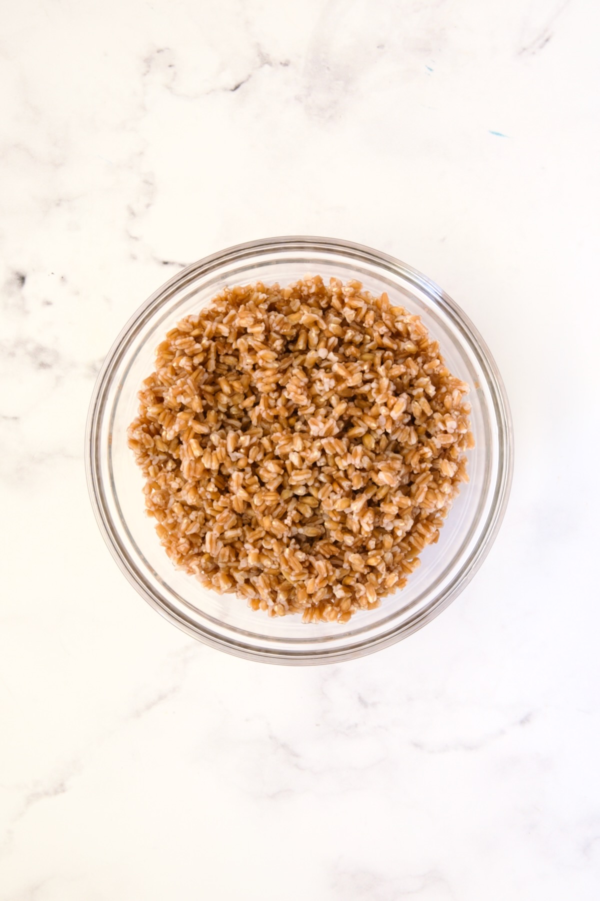 Cooked farro in glass bowl.