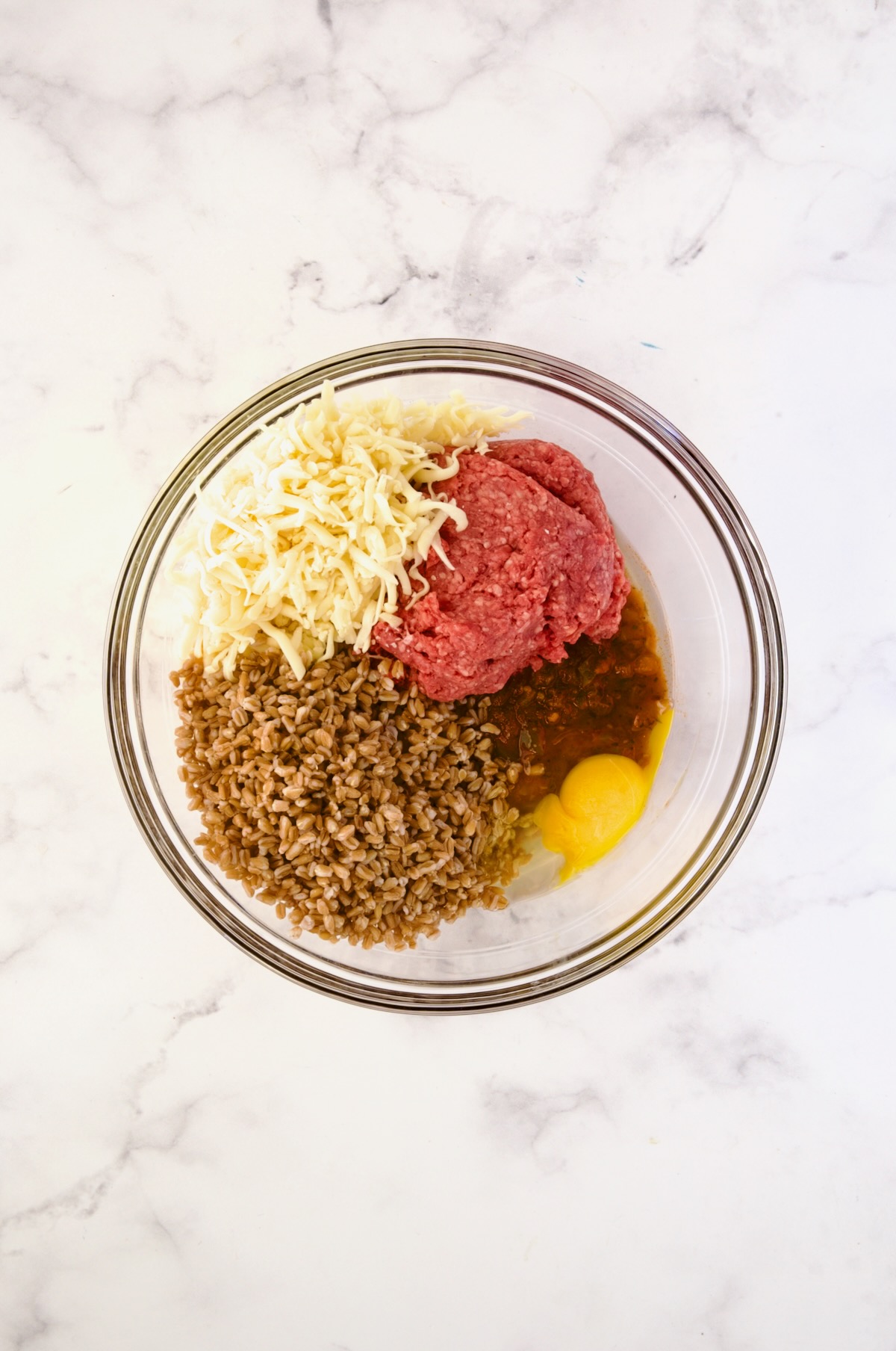 Ingredients for filling for Italian Stuffed Peppers in glass bowl before being mixed together.