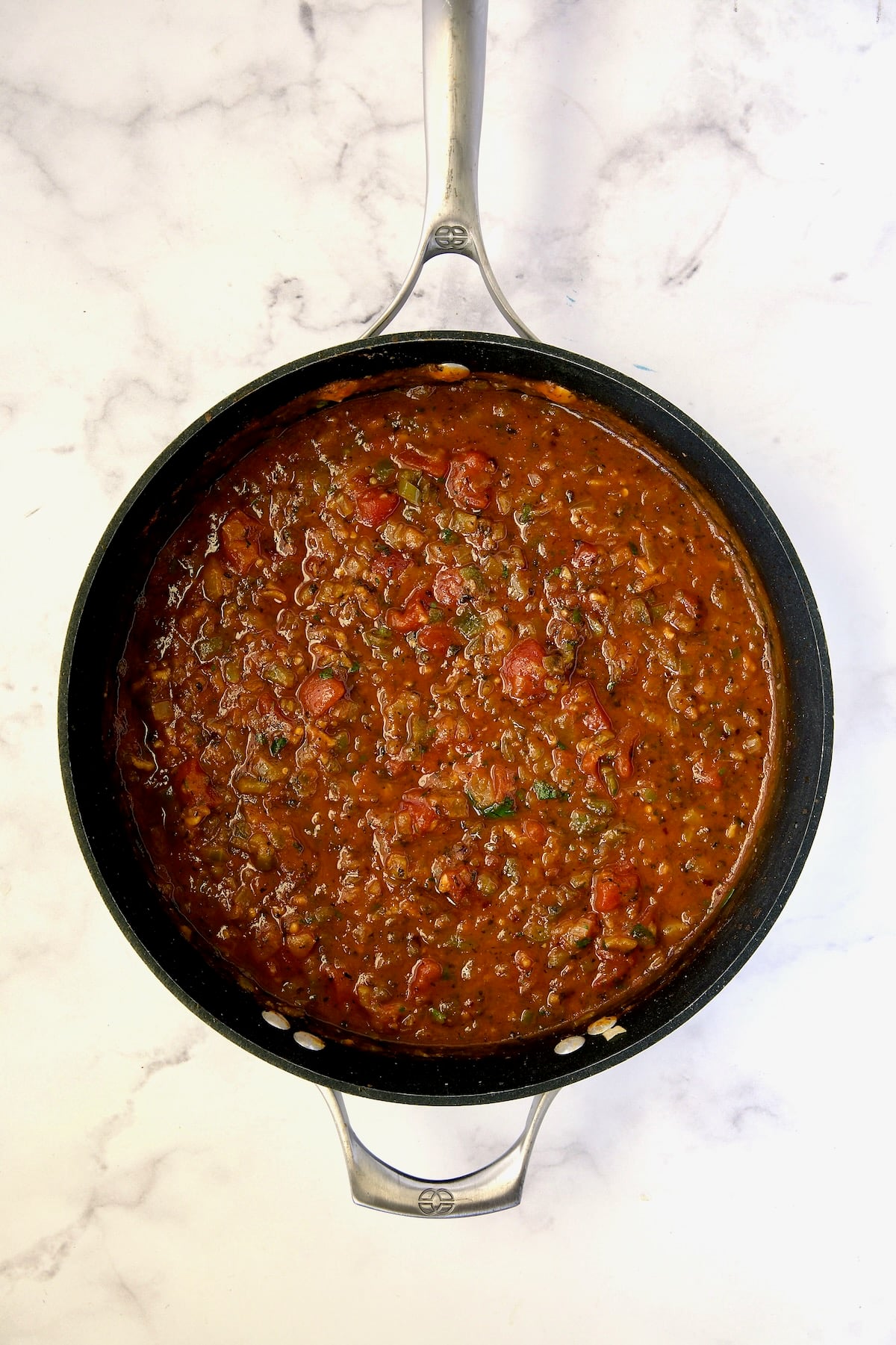 Tomato sauce for peppers in nonstick skillet.