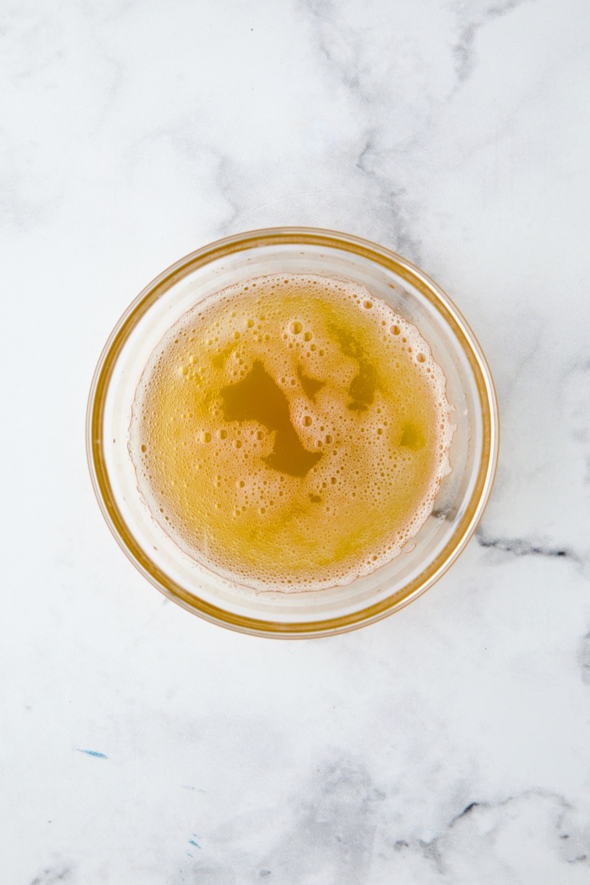 Browned butter in glass bowl.