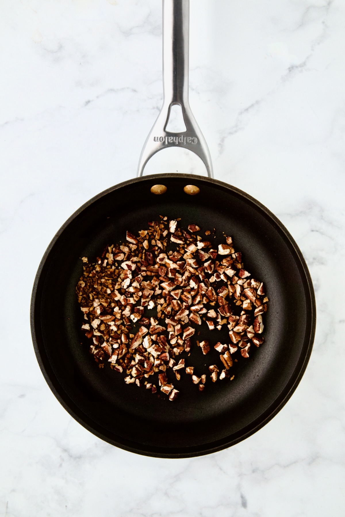 Toasted pecans in nonstick skillet.