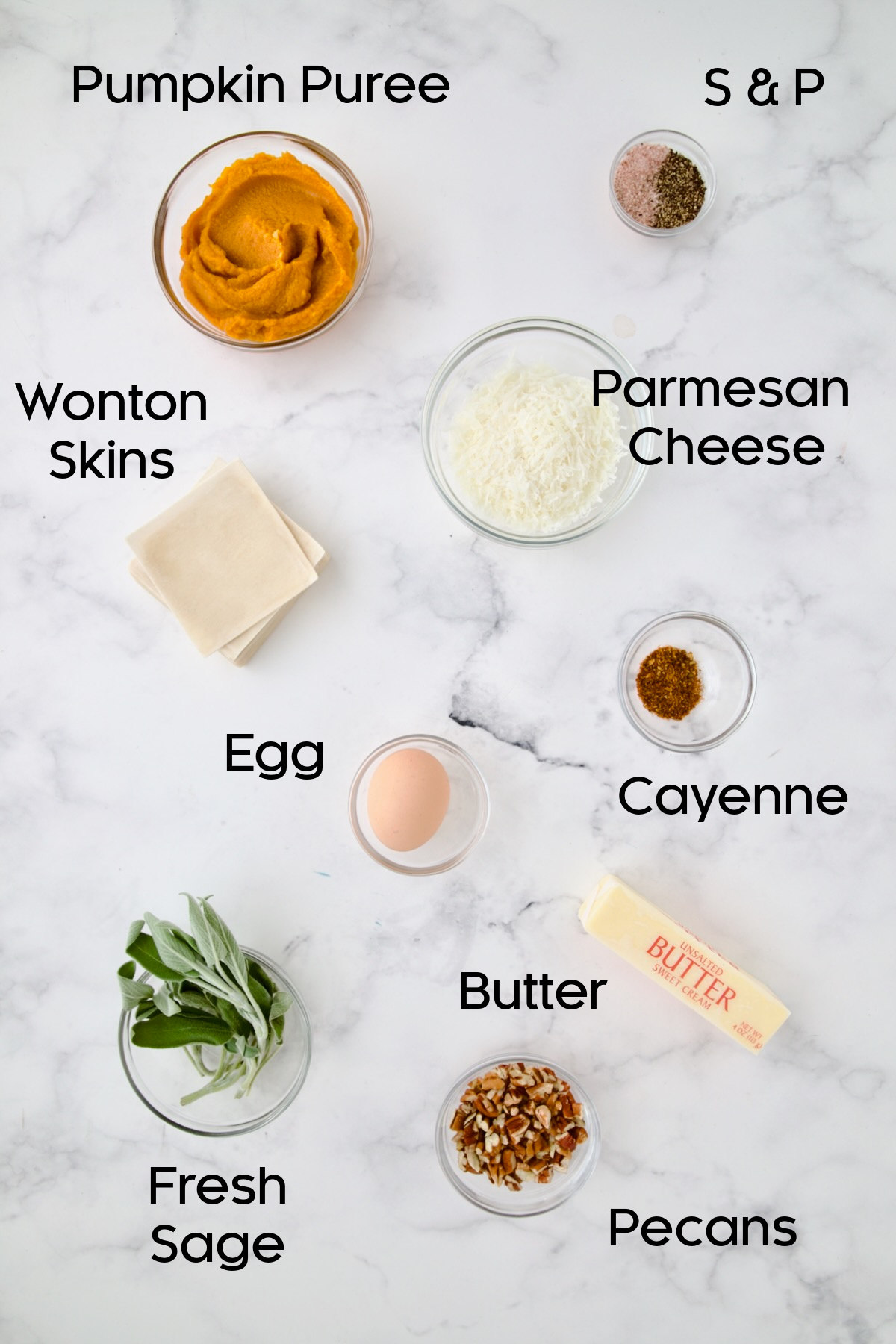 Ingredients for Pumpkin Ravioli with Sage Brown Butter in glass bowls.