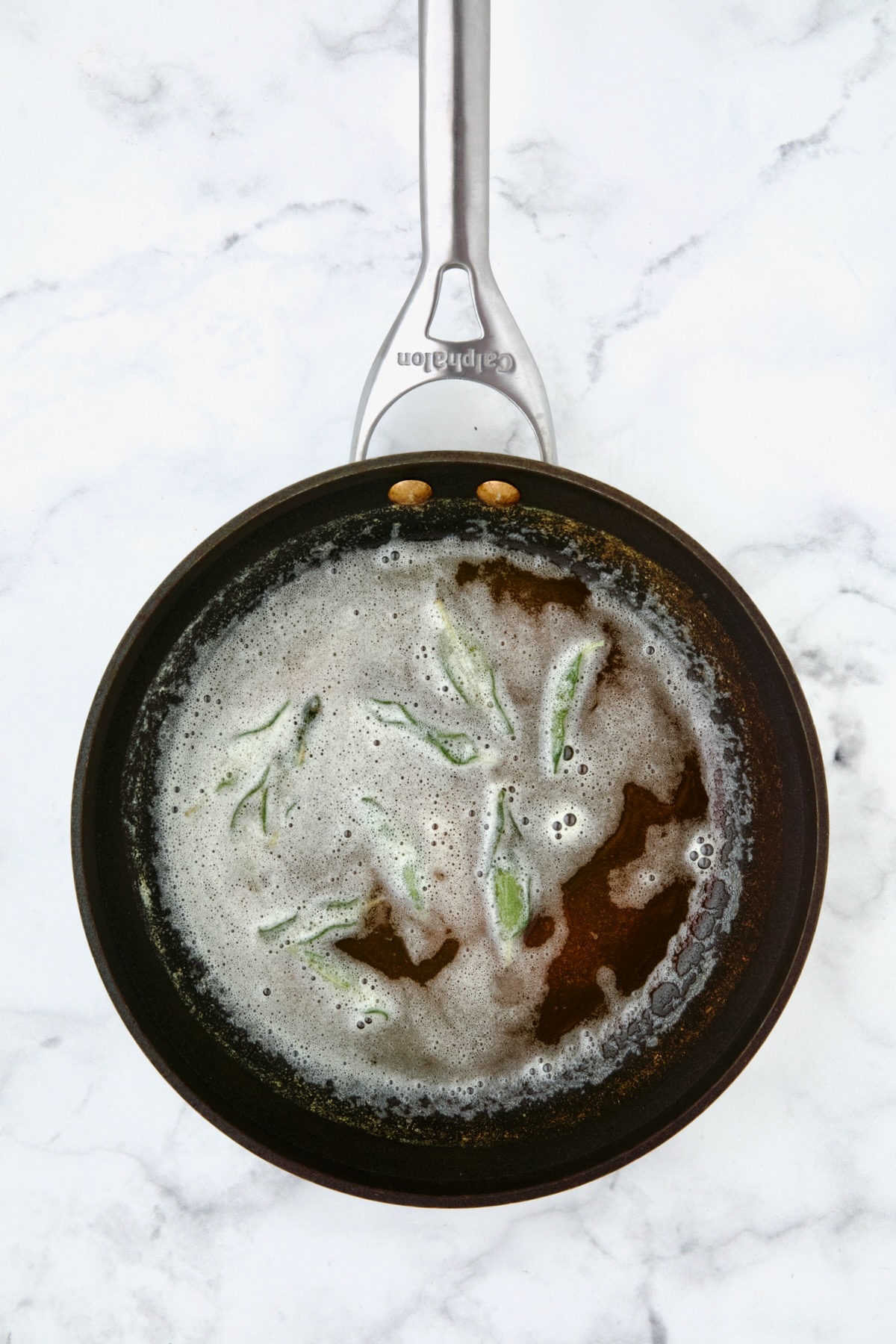 Fried sage leaves in foamy browned butter in nonstick skillet.