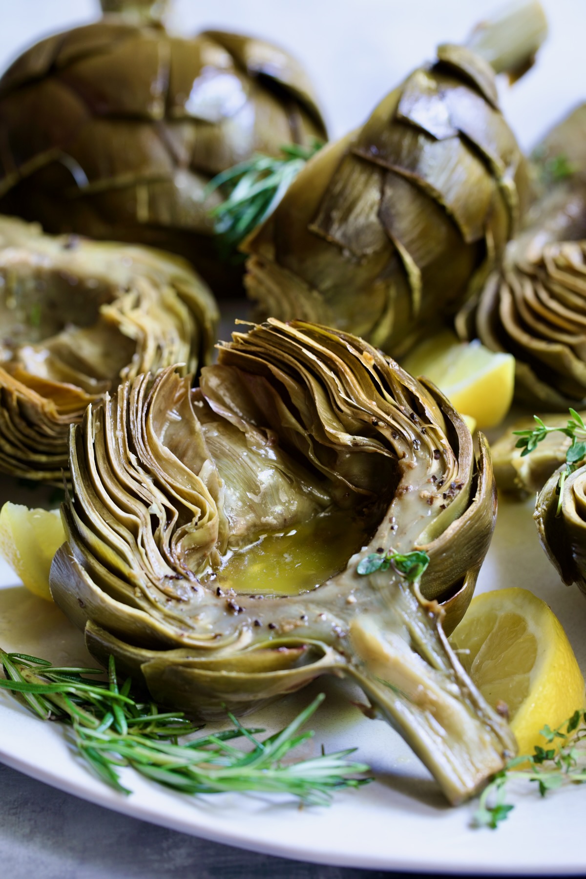 Roasted Artichoke with Garlic Butter in the well of the artichoke.