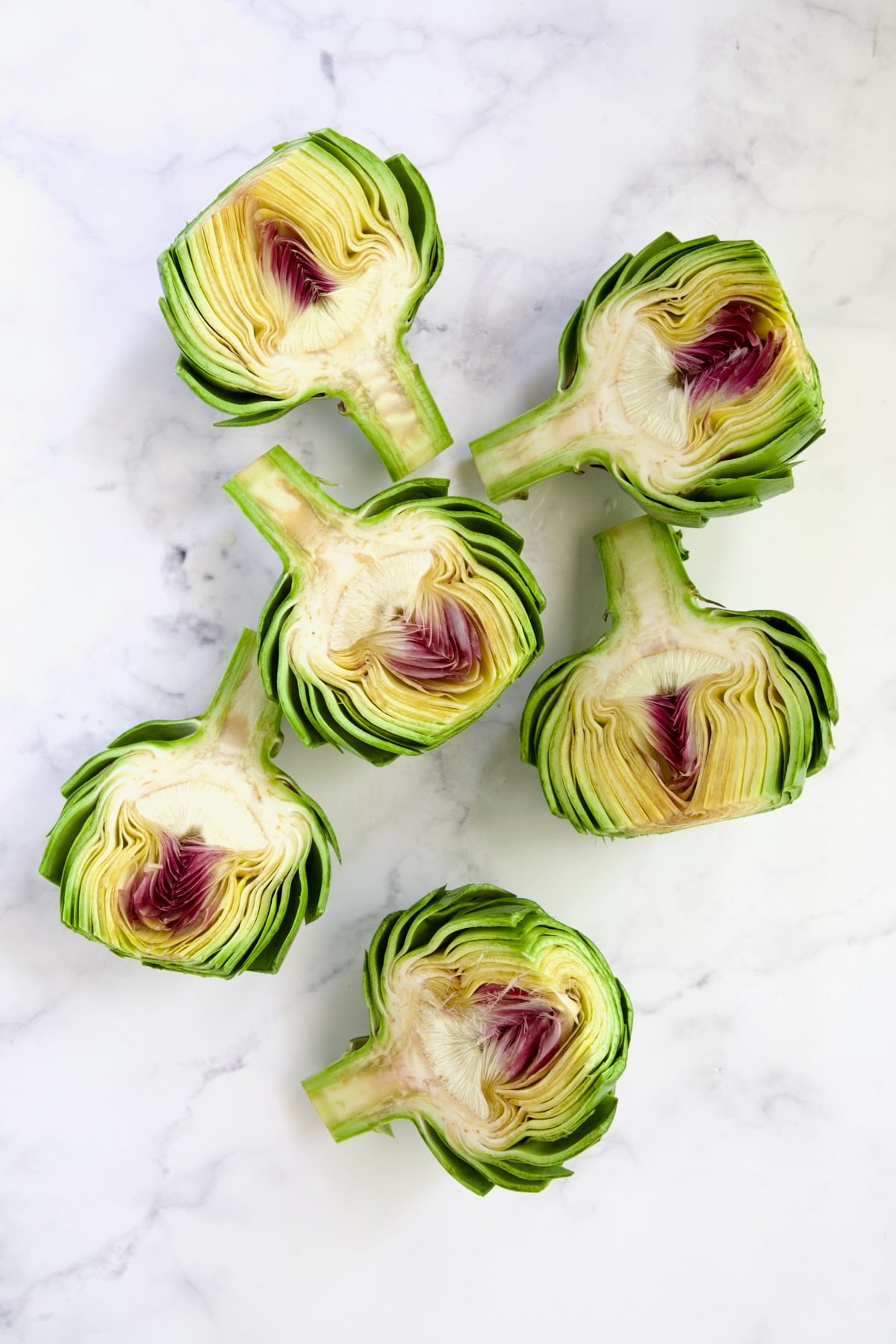 Six artichoke halves before the choke is removed.