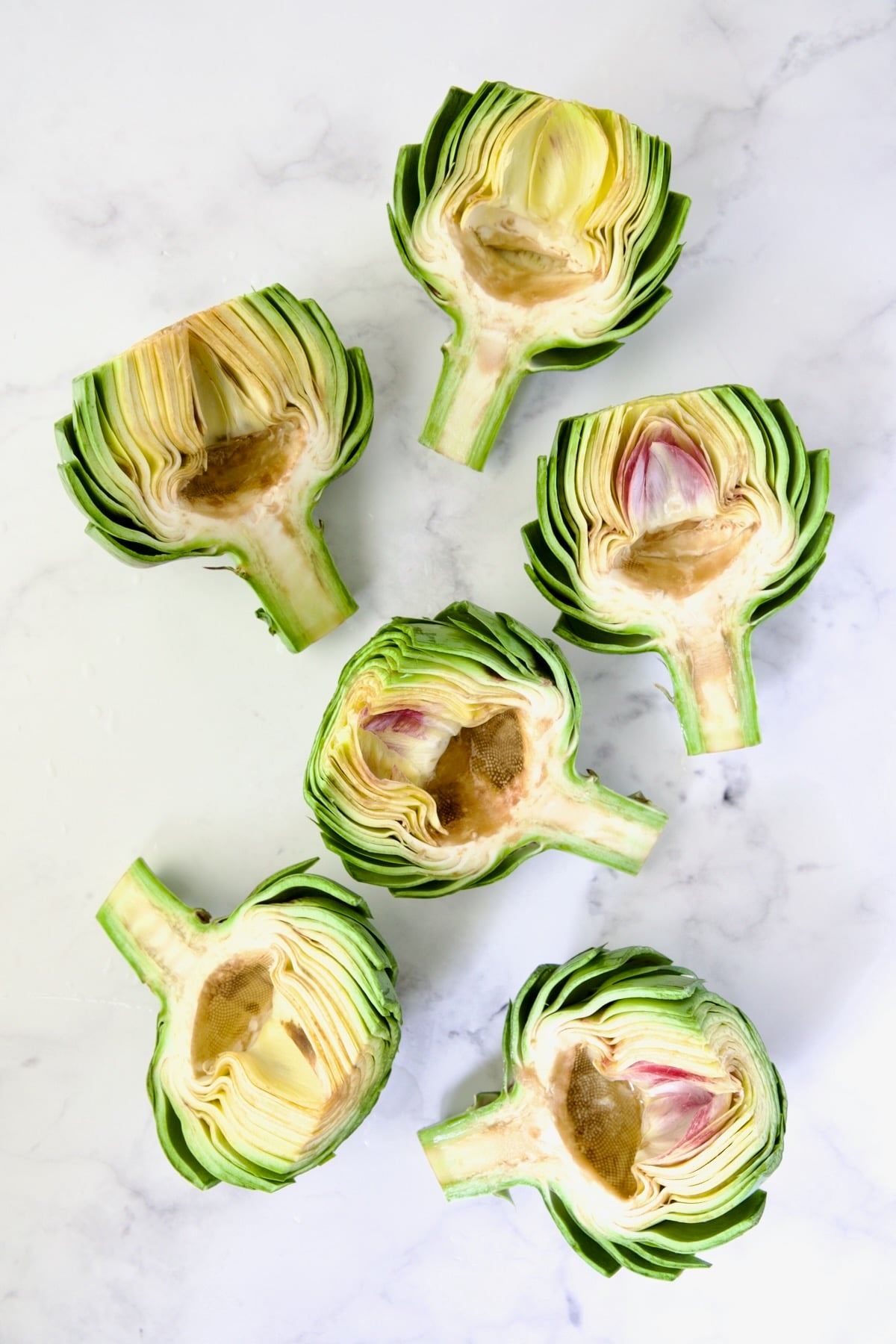 Six artichoke halves with choke removed.
