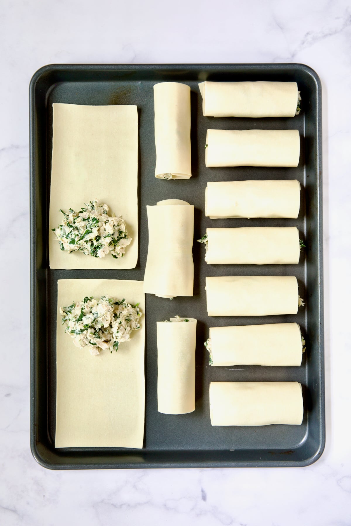 Photo demonstrating how to place filling on softened flat lasagna sheets.