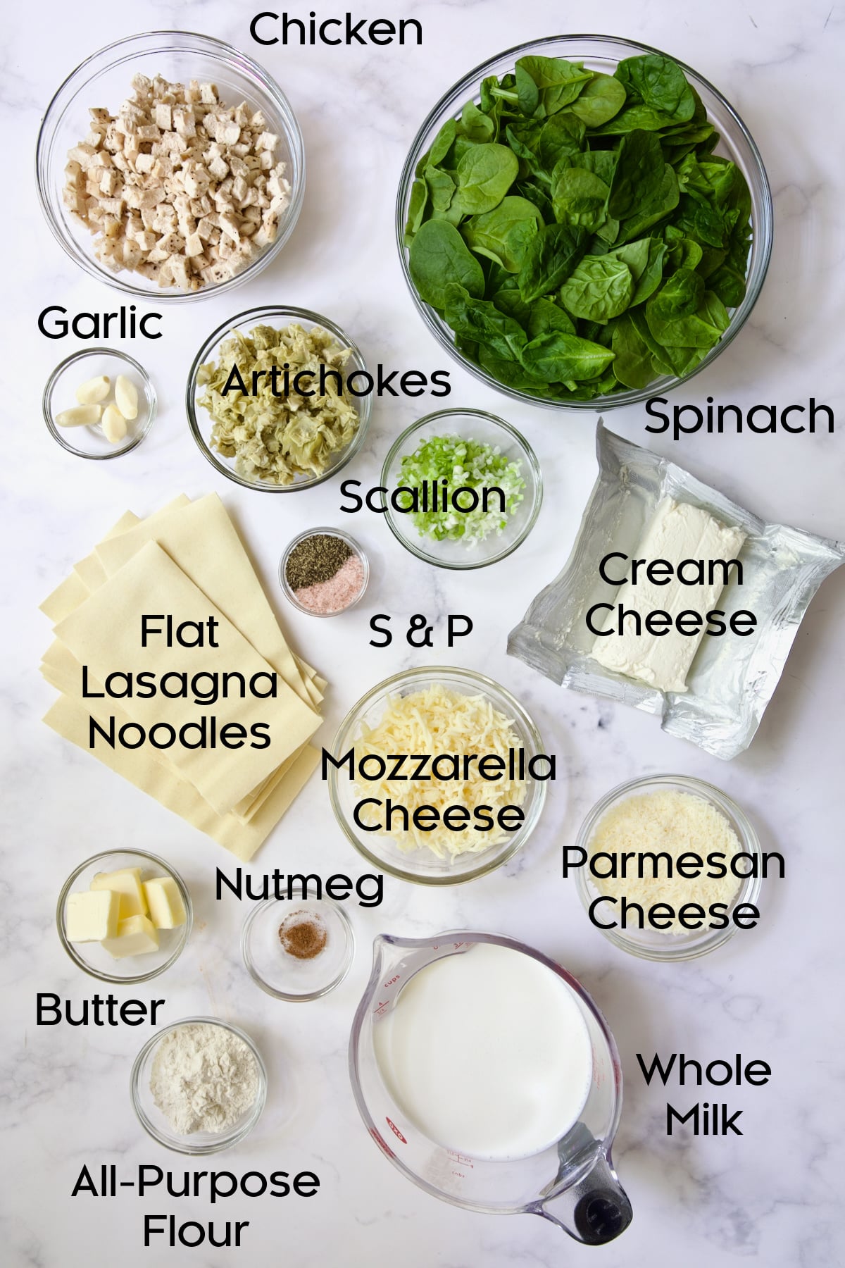Ingredients for Cannelloni with Chicken, Spinach and Artichokes in glass bowls.