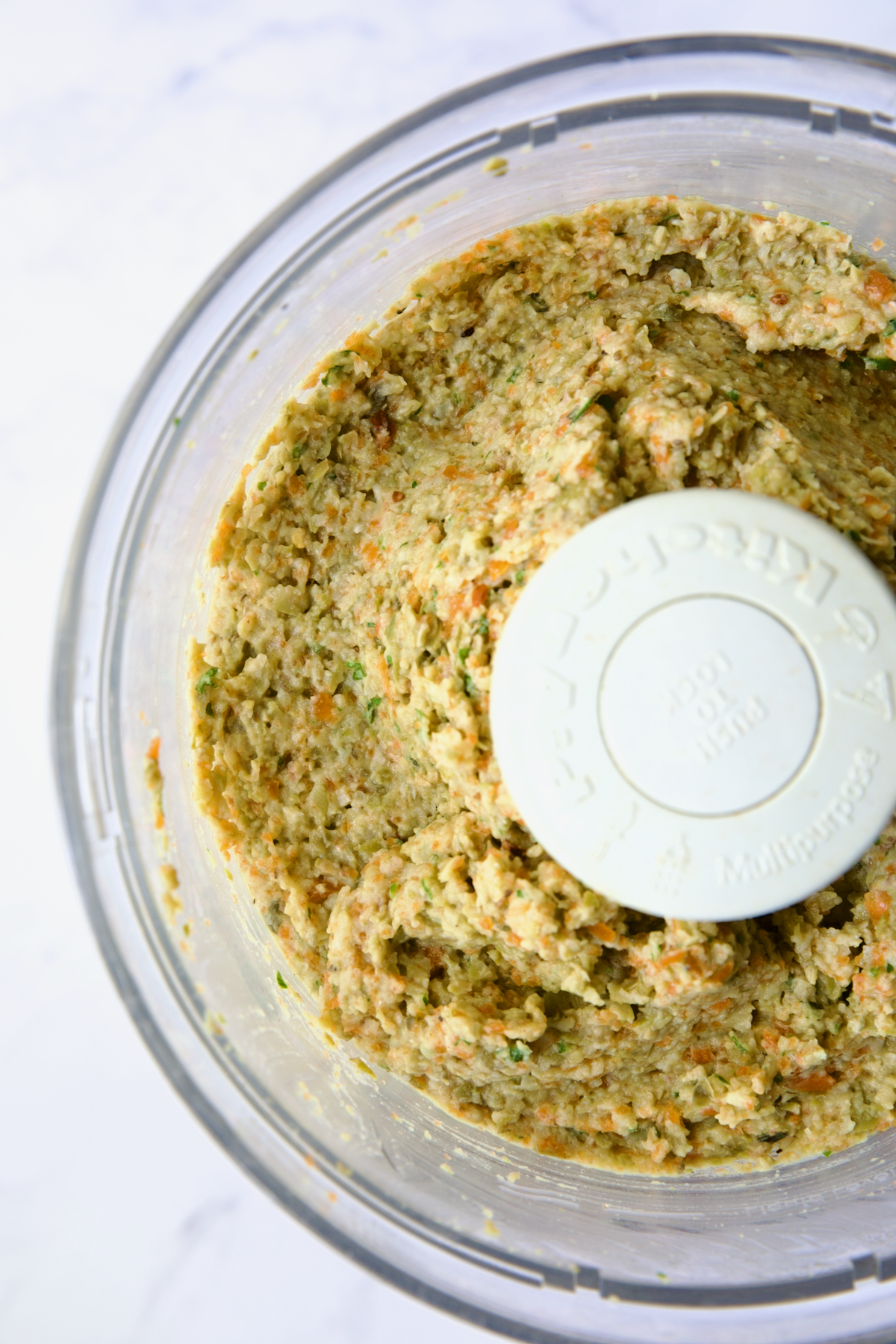 Close-up photo of Green Olive Eggplant Tapenade in food processor to show texture.