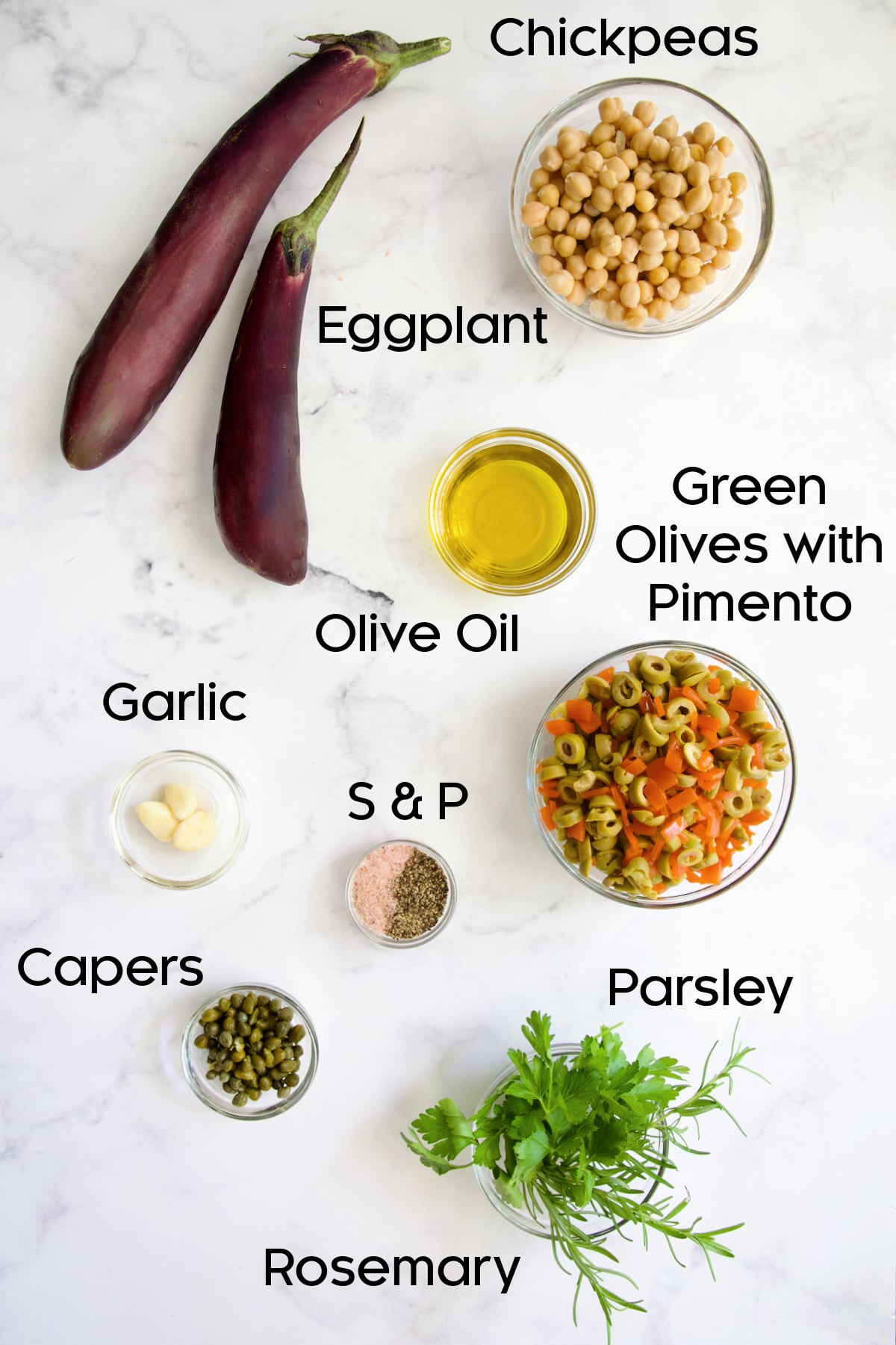 Ingredients for Green Olive Eggplant Tapenade in glass bowls.