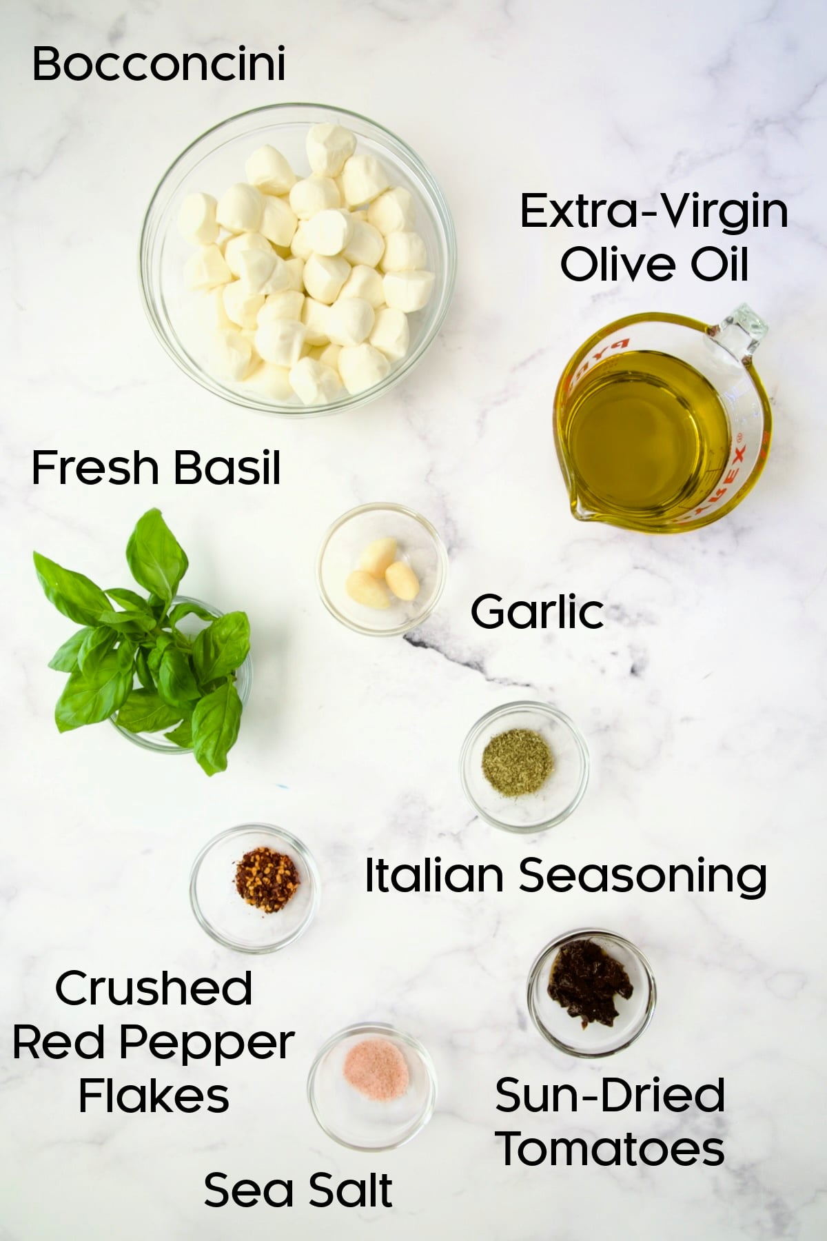 Ingredients for Marinated Mozzarella Balls in glass bowls.