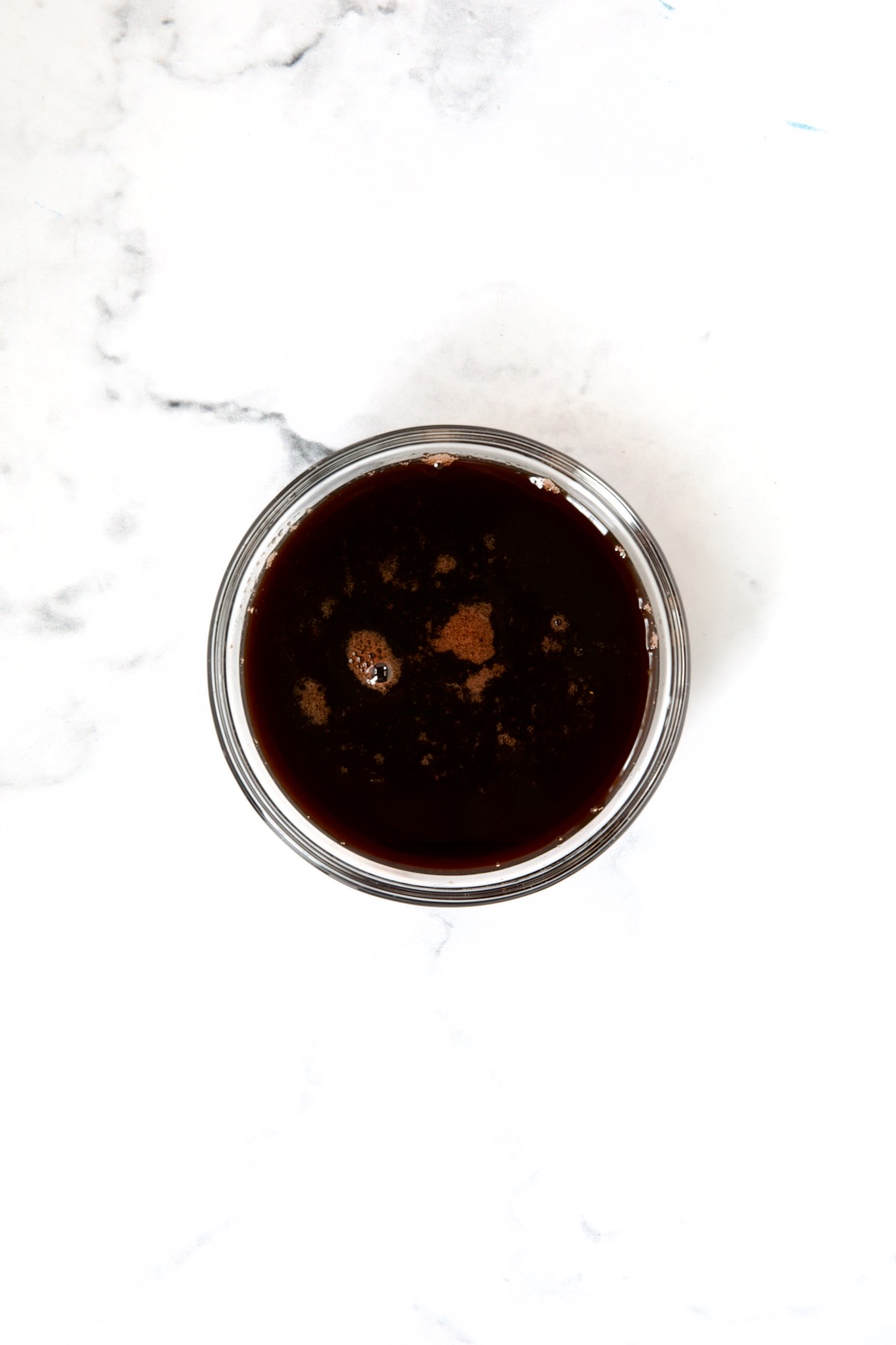 Red wine glaze in glass bowl.