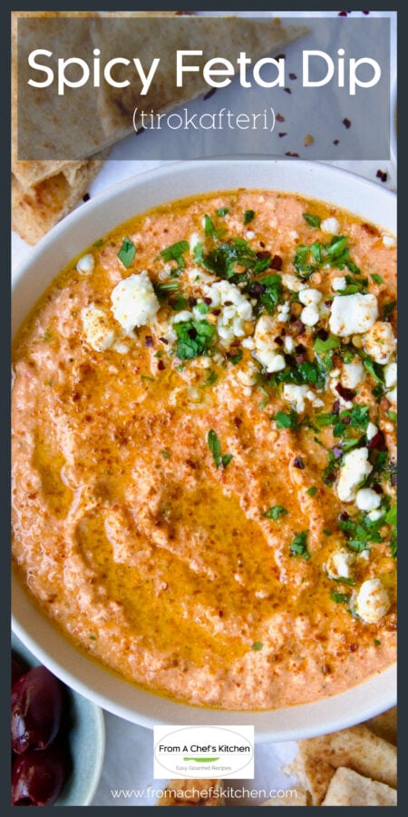 Spicy Feta Dip in white bowl garnished with crumbled feta cheese and parsley.