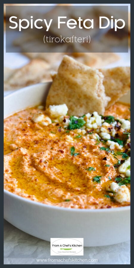 Spicy Feta Dip in white bowl garnished with parsley and crumbled feta cheese.