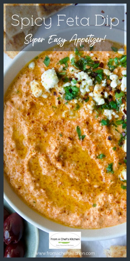 Spicy Feta Dip in white bowl garnished with parsley and crumbled feta cheese.