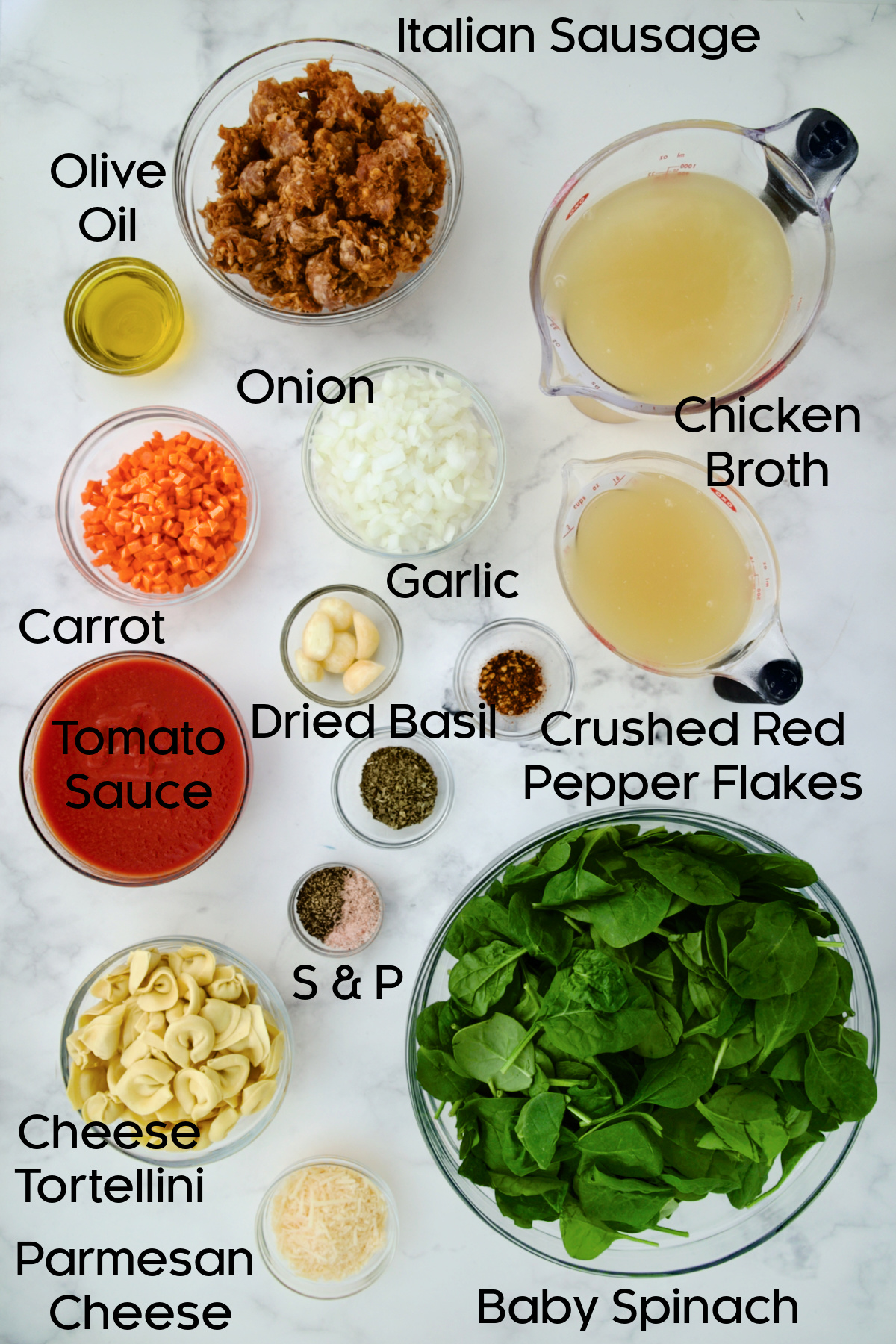 Ingredients for Sausage Spinach Tortellini Soup in glass bowls.