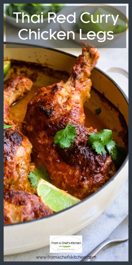 Thai red curry chicken leg in white enamel cast iron skillet.