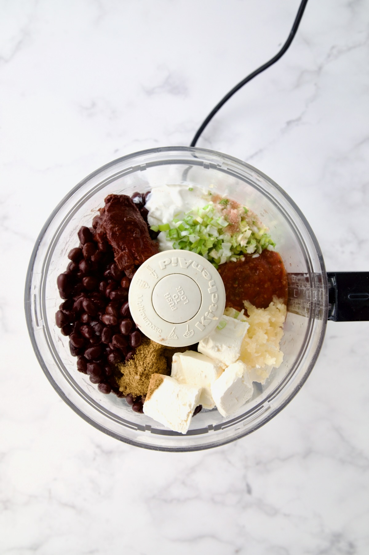 Ingredients for Black Bean Dip in food processor before being combined.