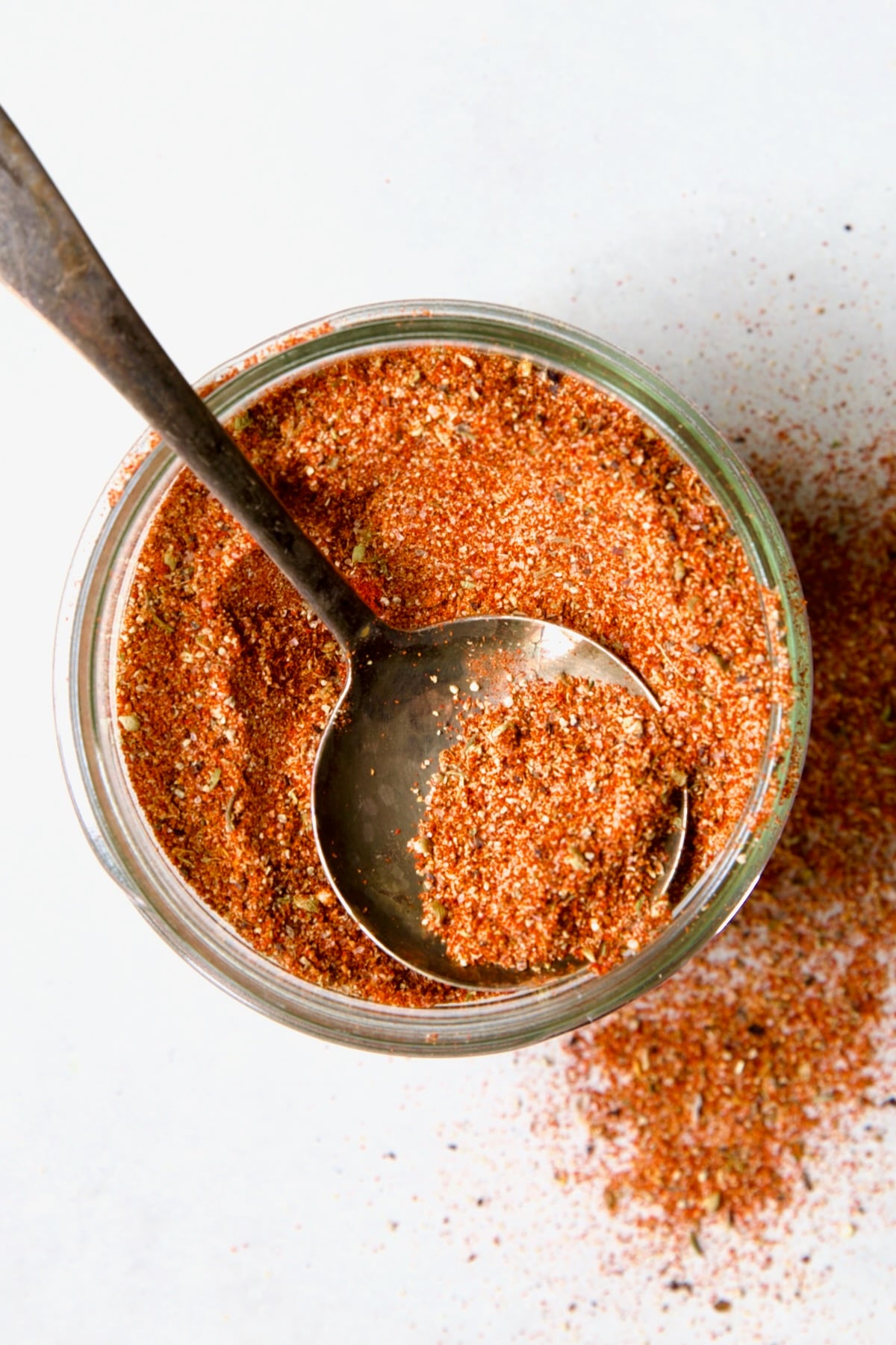 Jar of Blackening Seasoning with spoon scooping some out.