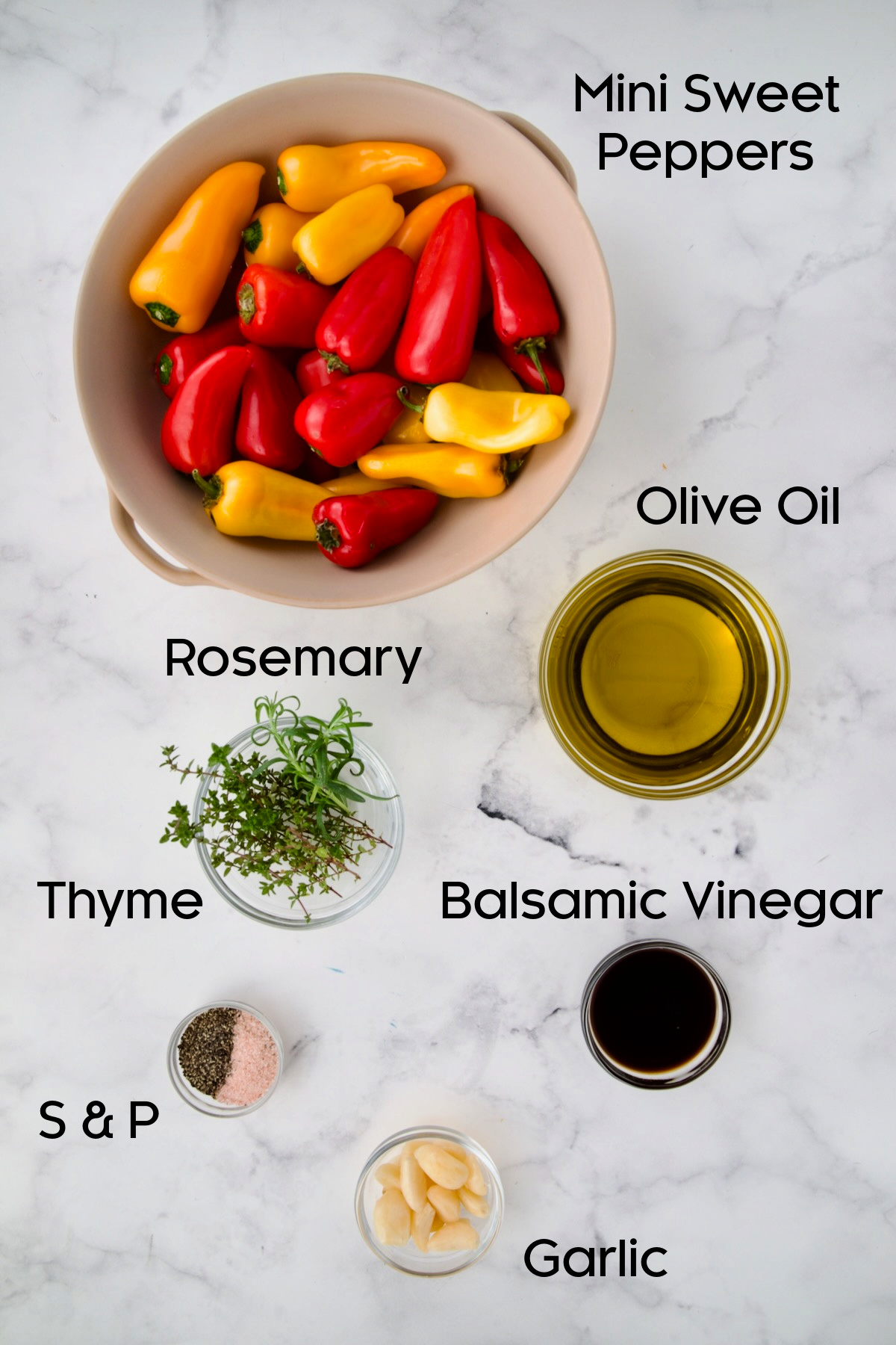Ingredients for Roasted Mini Peppers on marble countertop.