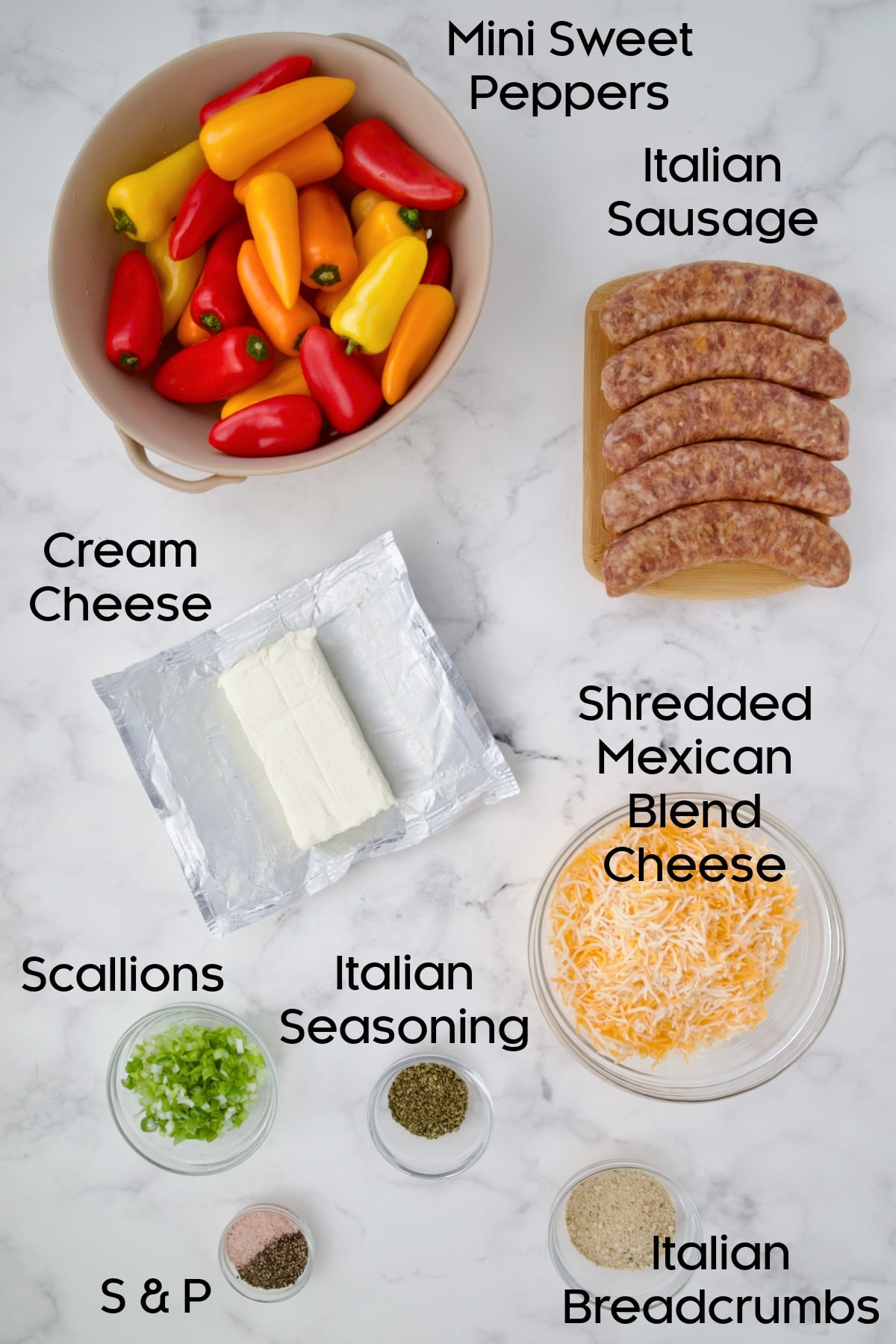 Ingredients for Stuffed Mini Peppers on white marble countertop.
