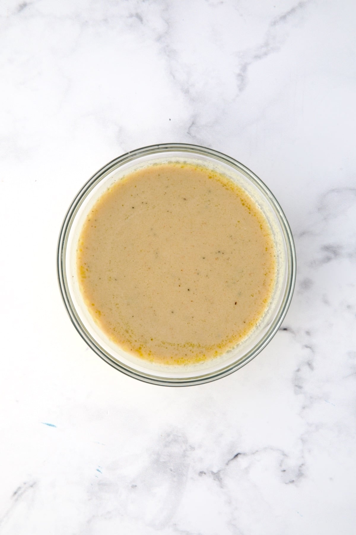 Lemon Tahini Dressing in glass bowl.