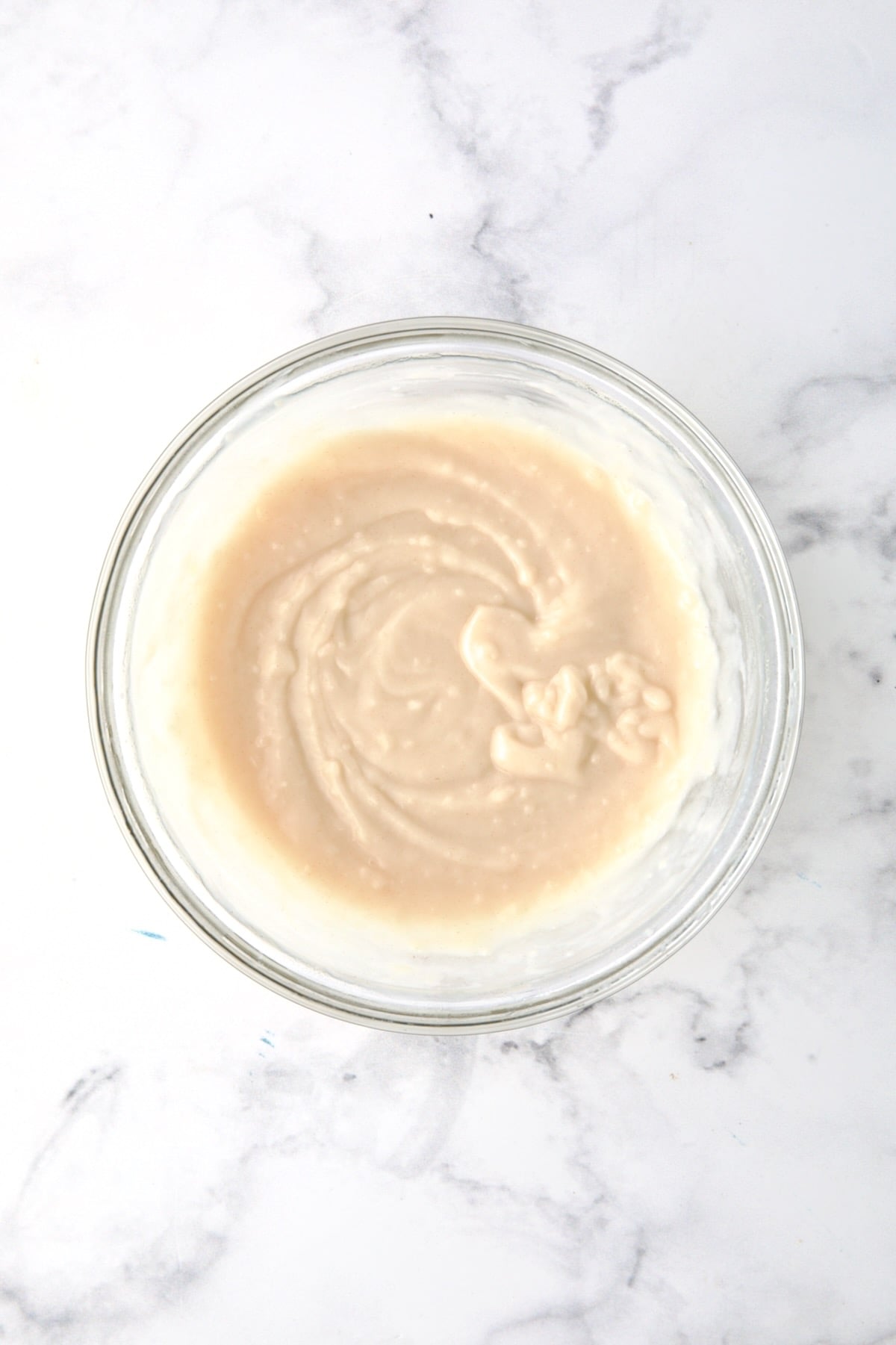 Slurry of flour and broth in glass bowl.