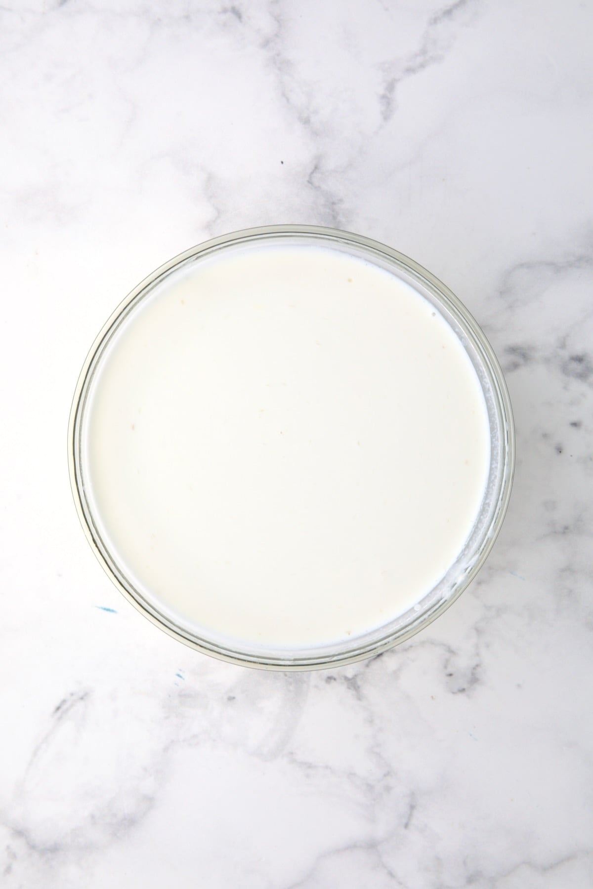 Combination of half-and-half and flour slurry in glass bowl.