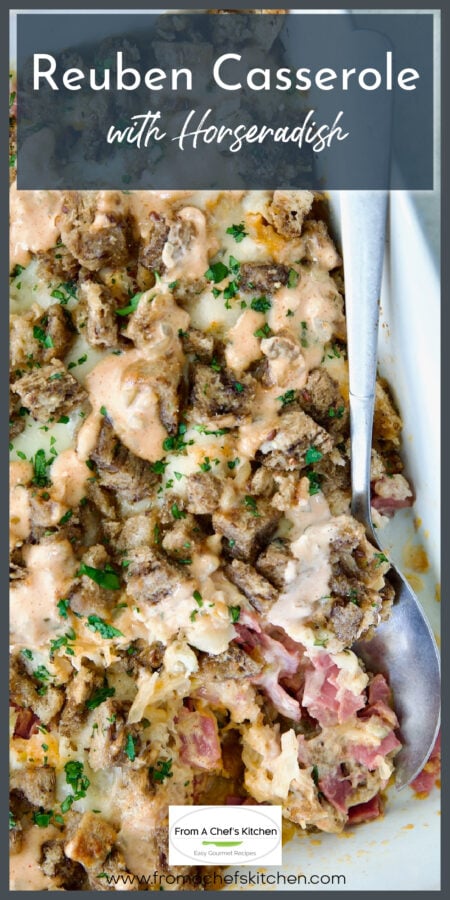 Reuben Casserole in white baking dish with serving spoon.