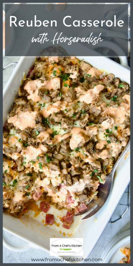 Reuben Casserole in white rectangular baking dish with serving spoon and a serving removed.