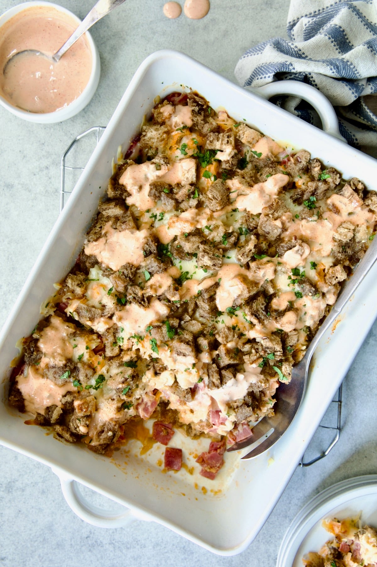 Reuben Casserole in white rectangular baking dish on cooling rack.