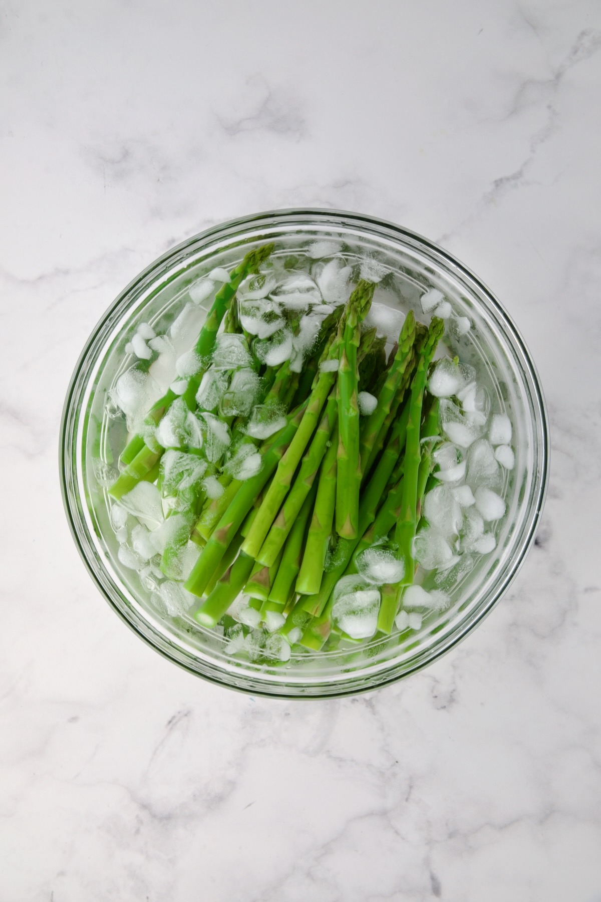 Blanched asparagus in ice water.