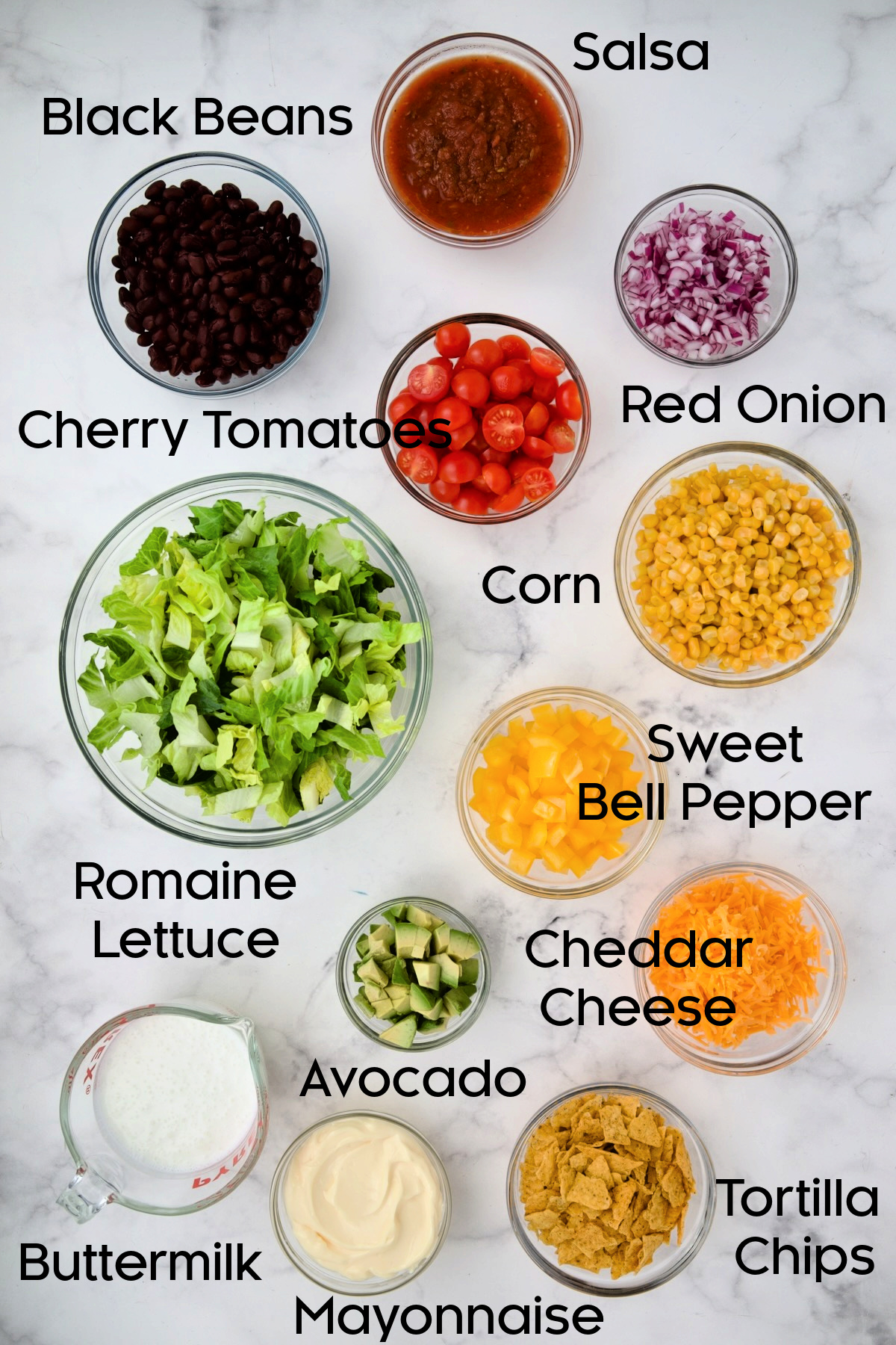 Ingredients for Southwestern Layered Salad in glass bowls.