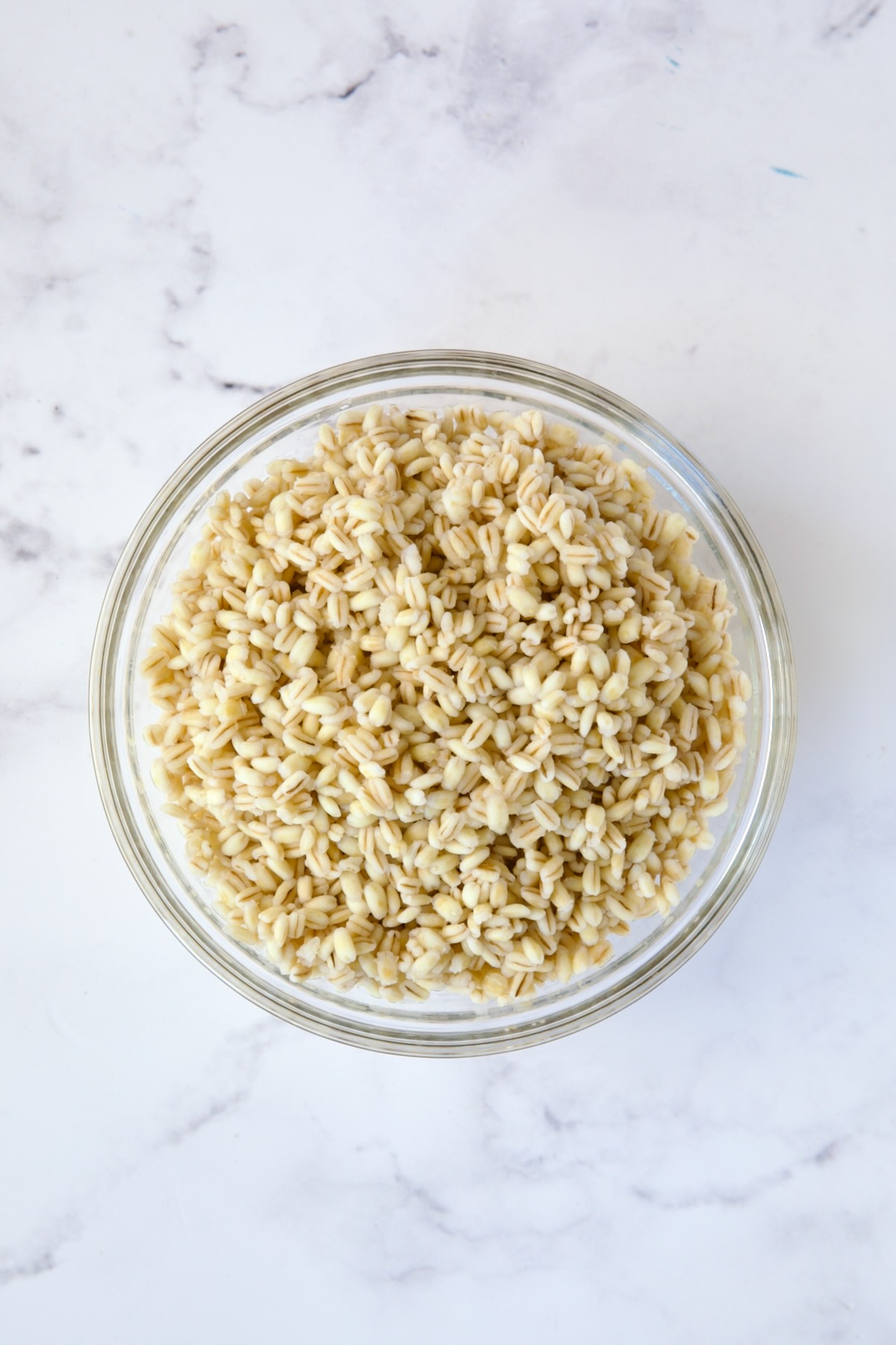 Cooked barley in glass bowl.