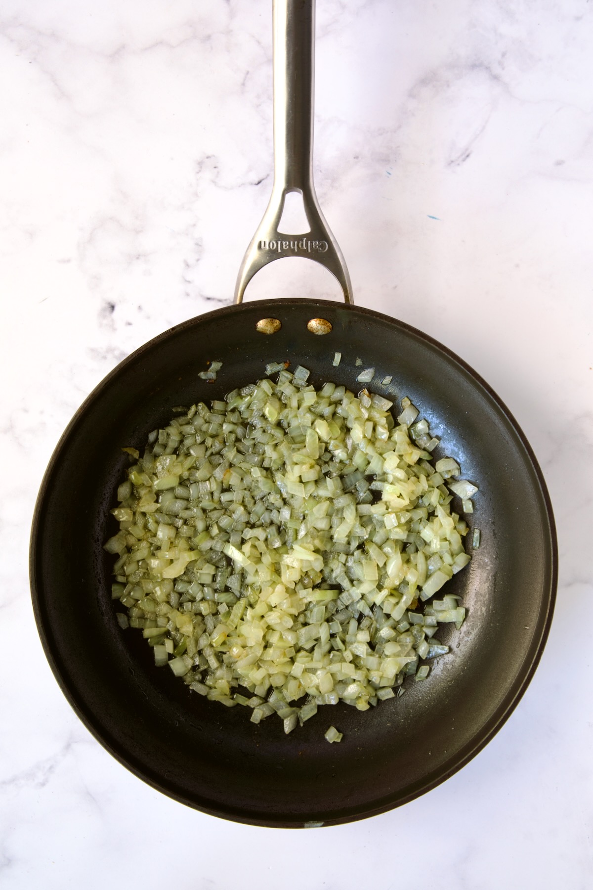 Cooked diced onion in nonstick skillet.