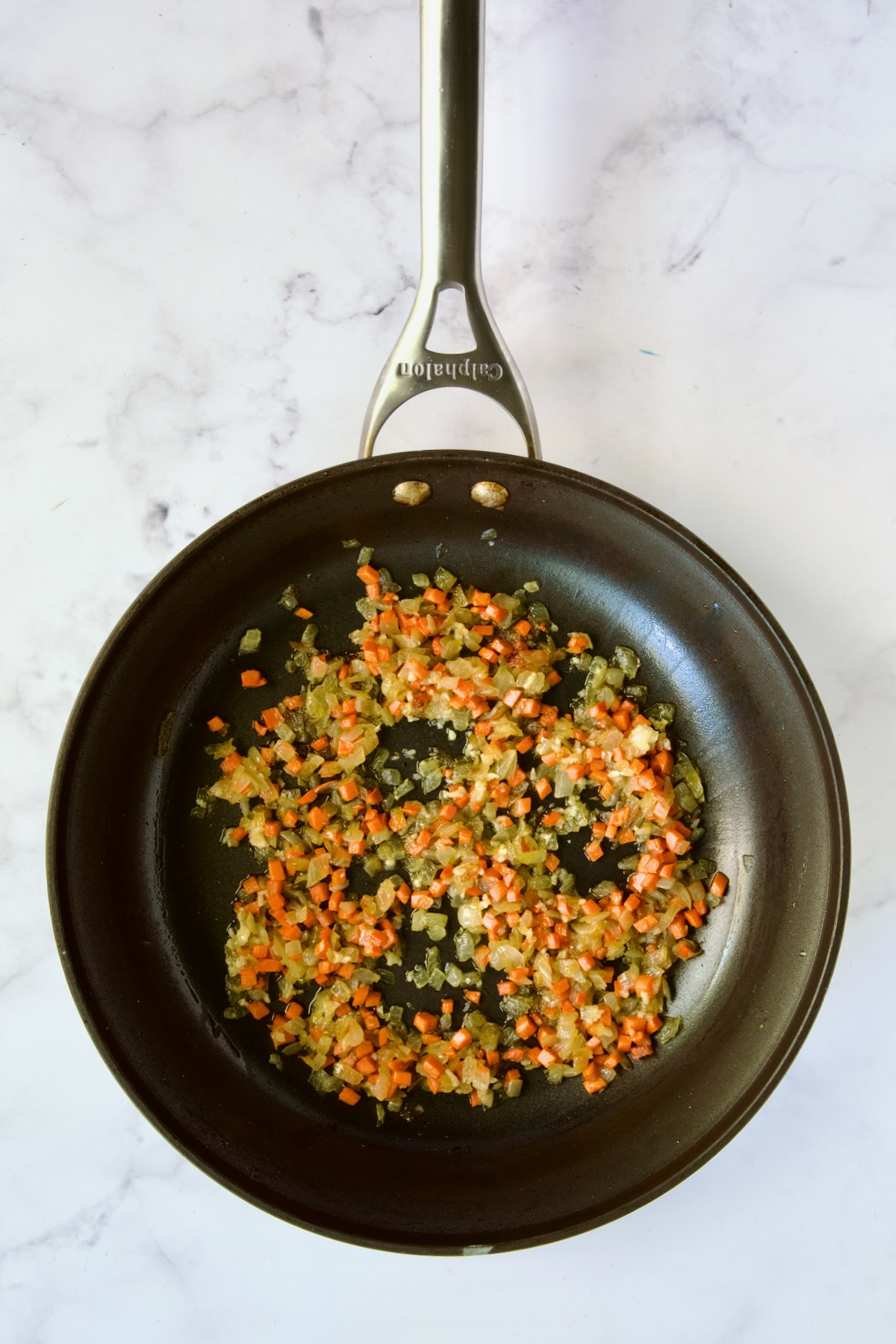Cooked diced onion and carrot in nonstick skillet.