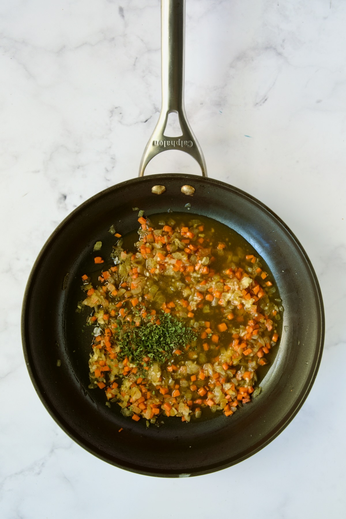 Cooked diced onion, diced carrot, garlic and broth in nonstick skillet.