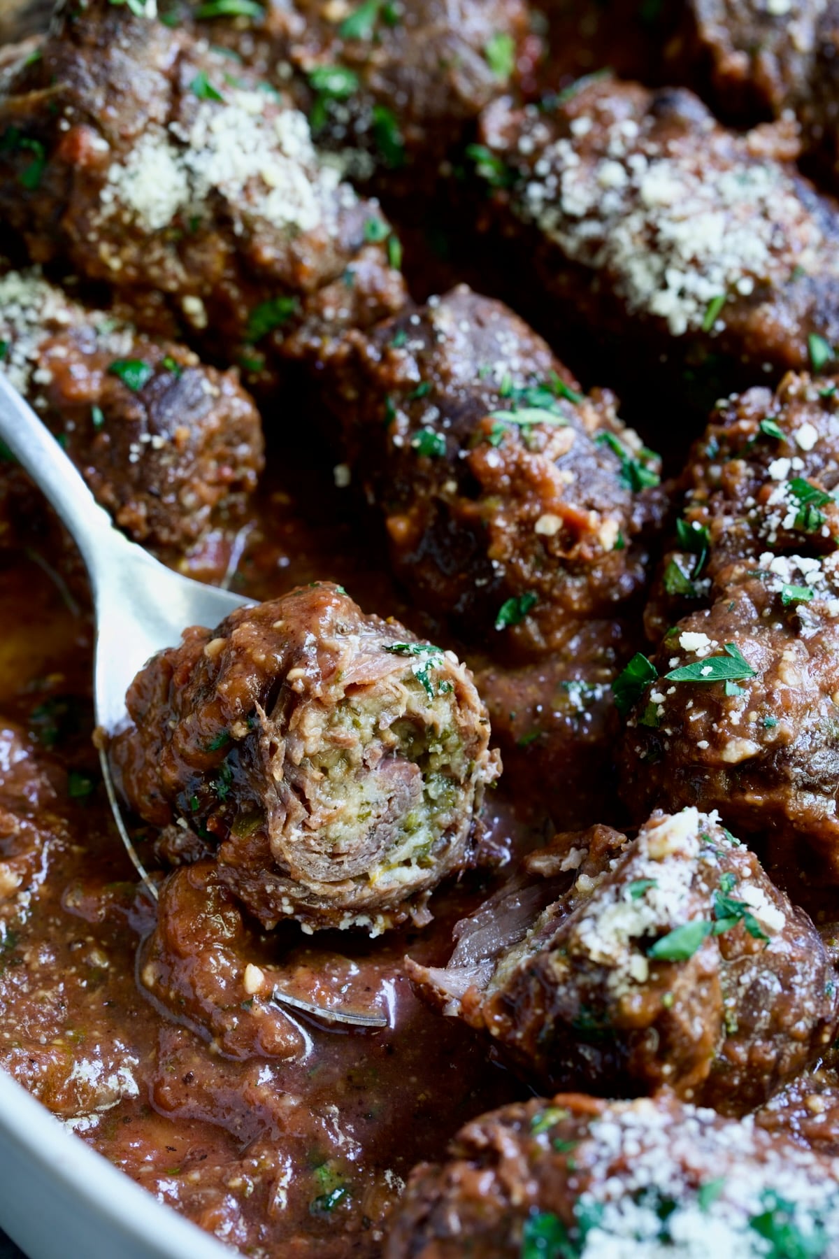 Beef Braciole cut in half to expose filling.