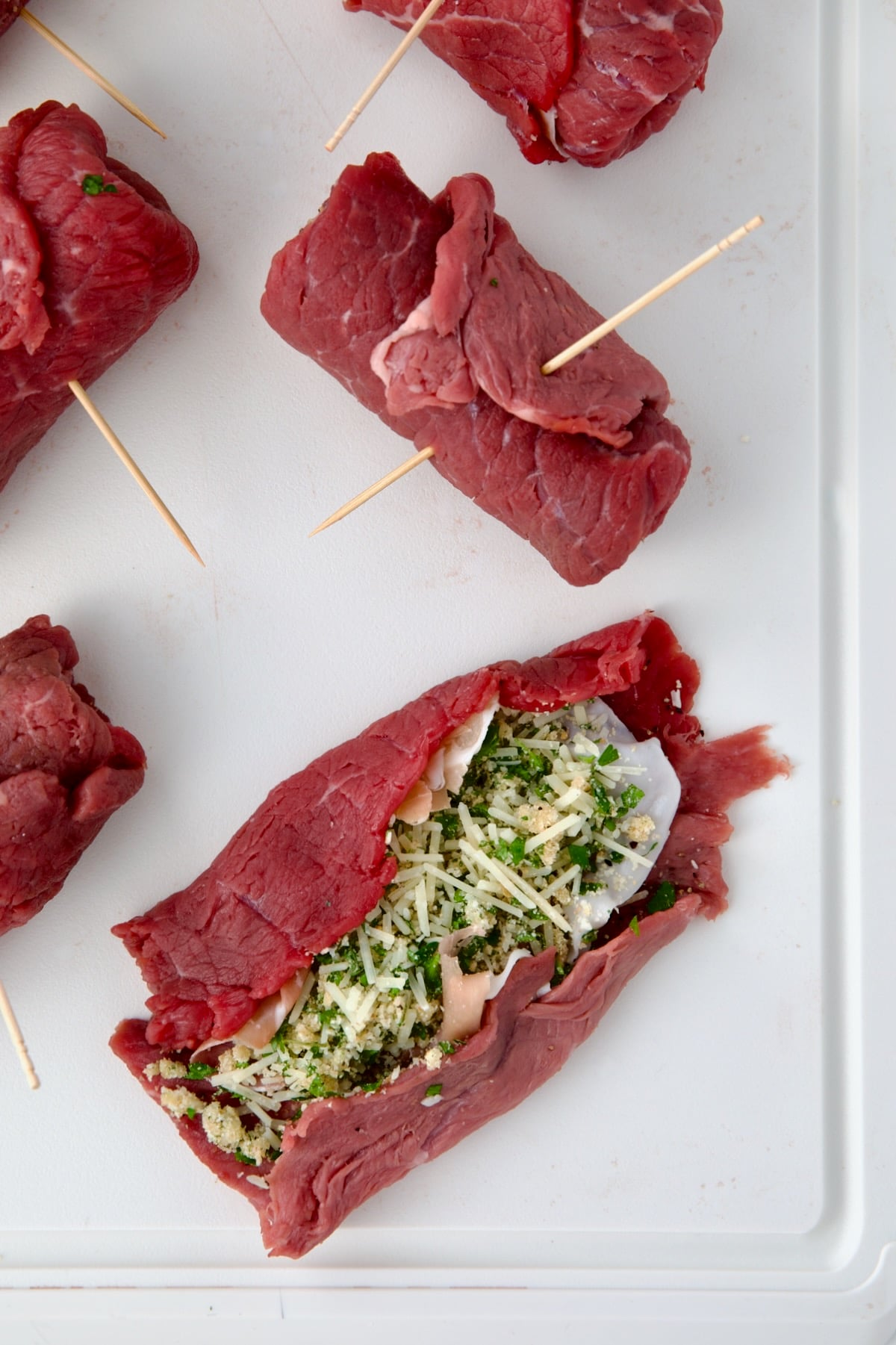 Close-up of a piece of semi-rolled Beef Braciole demonstrating how to roll them.